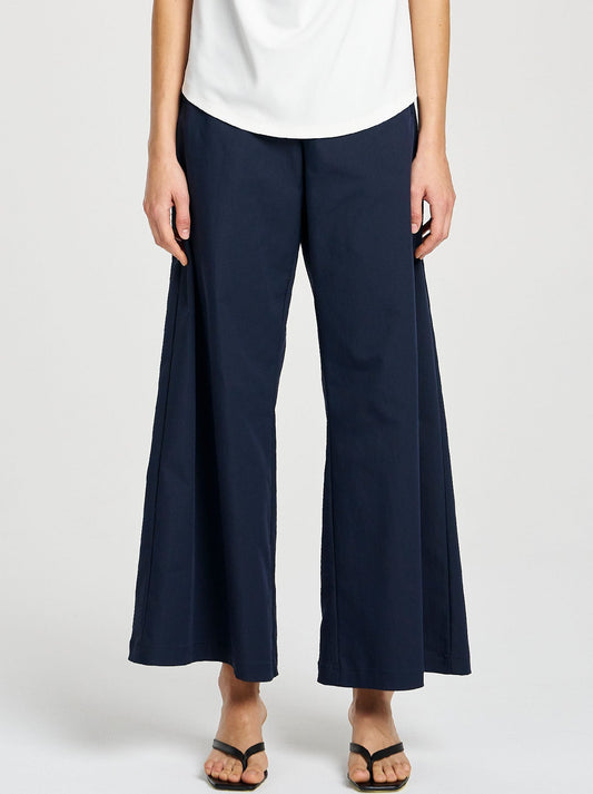Image of a model wearing Pants. Productname: MELA PURDIE SUIT PANT in Indigo colour by brand - Mela Purdie