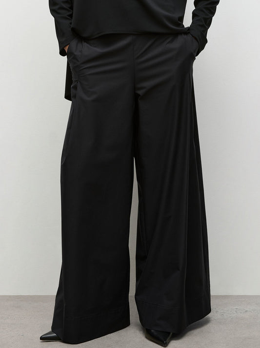 Image of a model wearing Pants. Productname: Mela Purdie Vent Pant in Black colour by brand - Mela Purdie