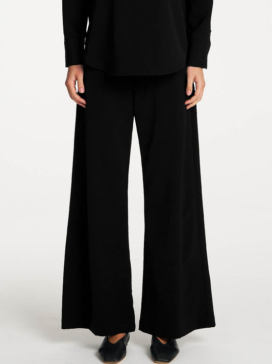 Image of a model wearing Pants. Product name - Mela Purdie Suit Pant in Black colour by brand - Mela Purdie