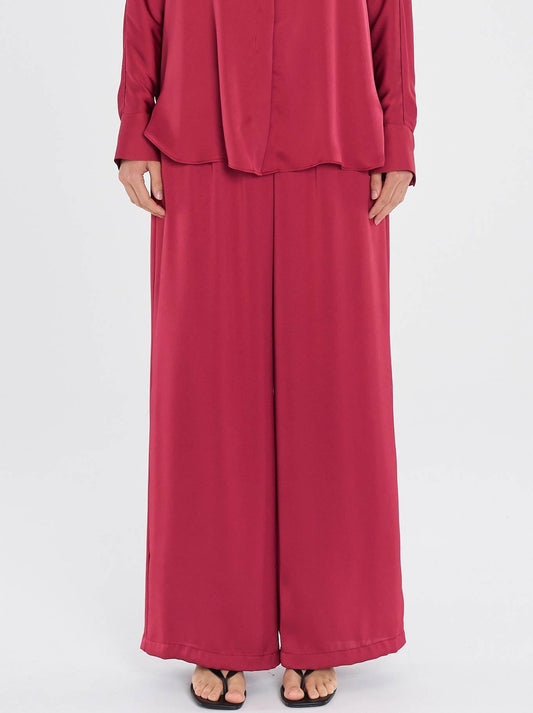 Image of a model wearing Pants. Productname: MELA PURDIE MAXI PACE PANT in Claret colour by brand - Mela Purdie