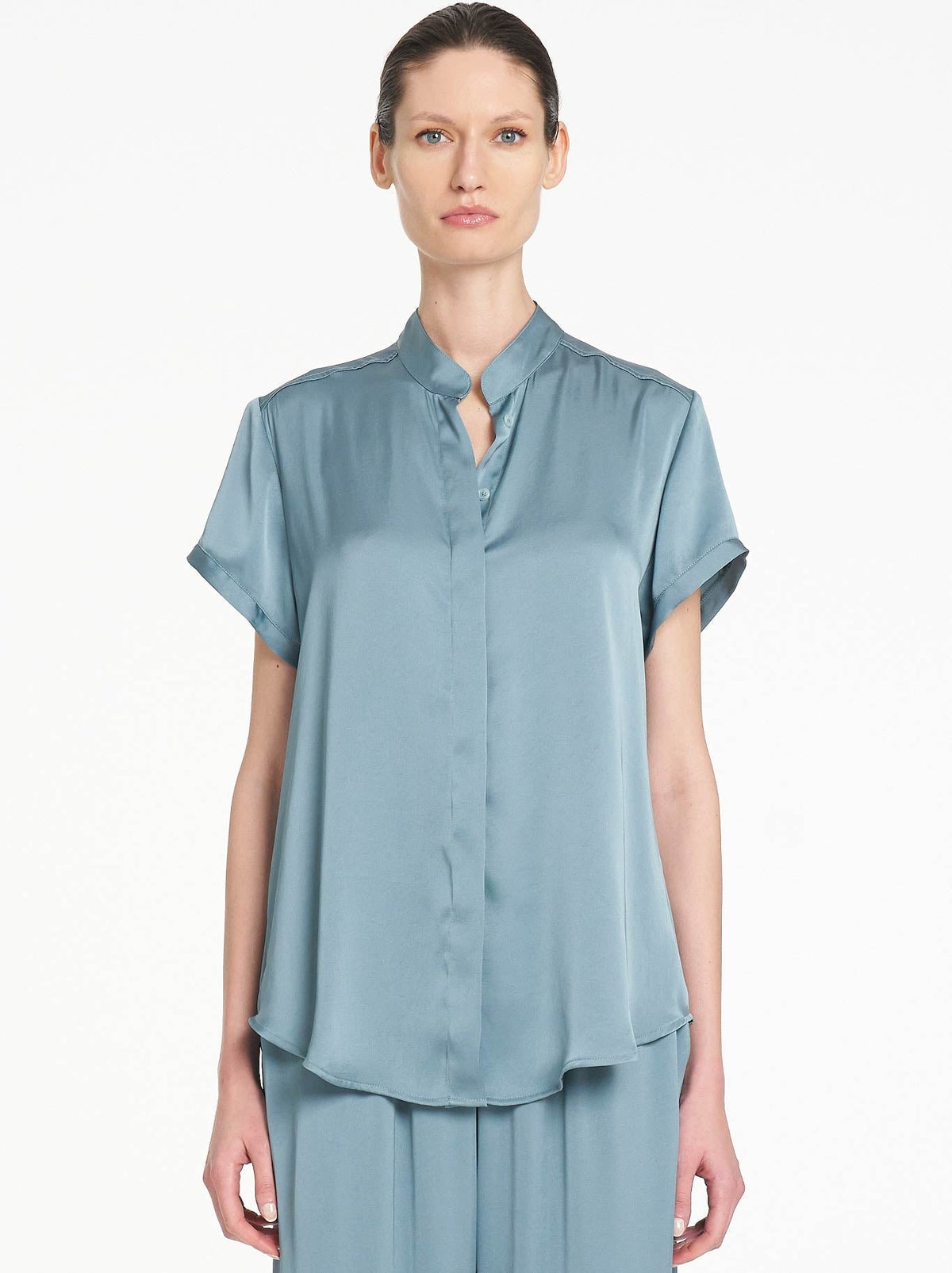 Image of a model wearing Tops. Product name - MELA PURDIE SOFT STAND SHIRT in Nile colour by brand - Mela Purdie