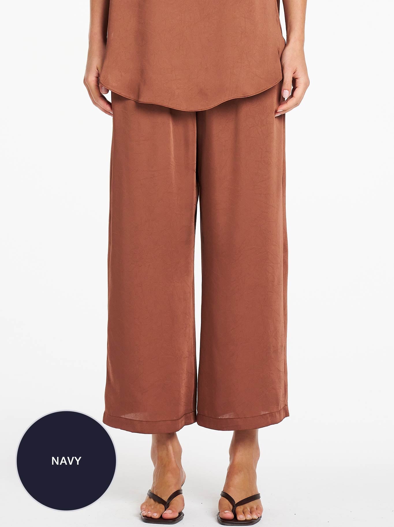 Image of a model wearing Pants. Product name - MELA PURDIE PACE PANT in Navy colour by brand - Mela Purdie