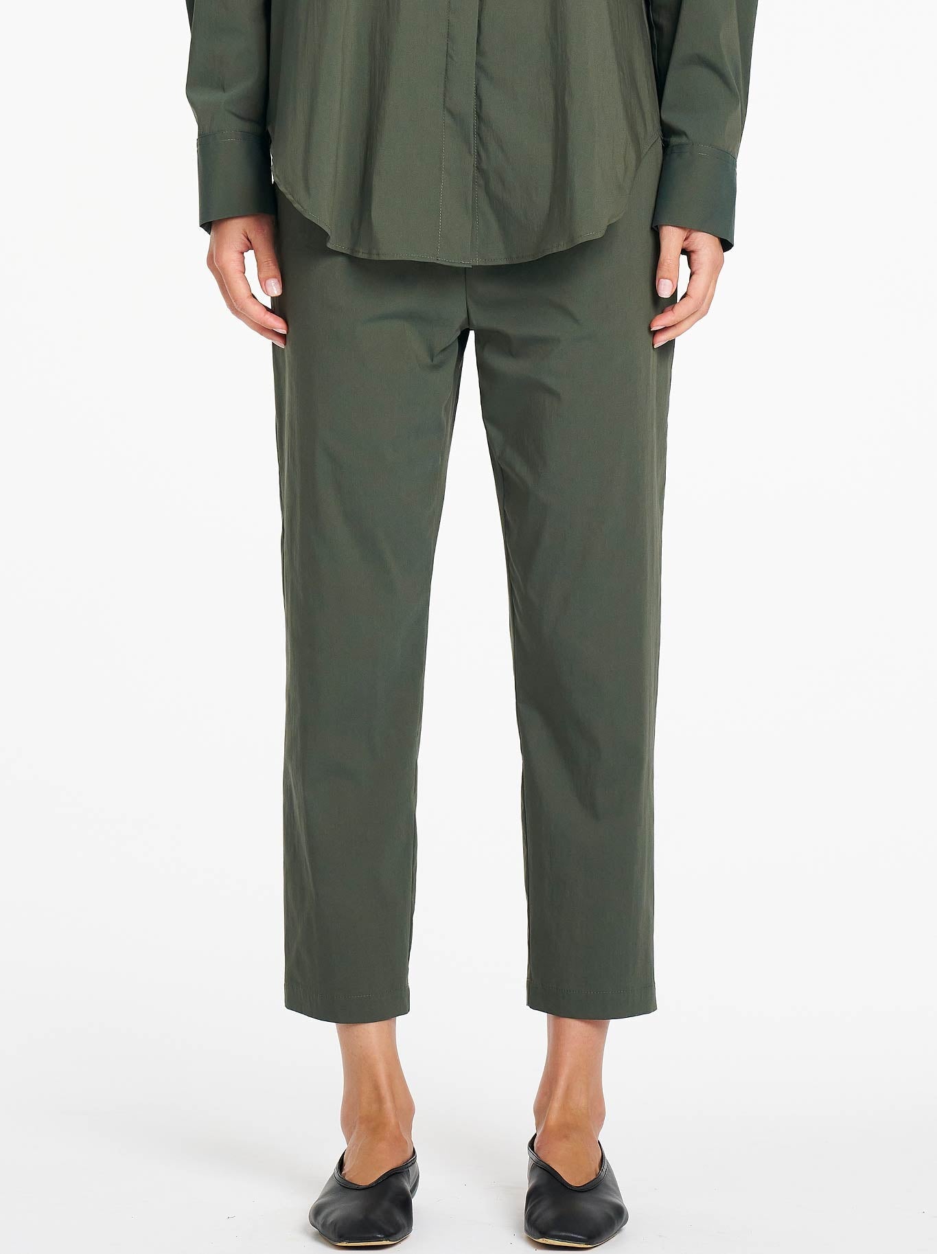 Image of a model wearing Pants. Product name - Mela Purdie Nomad Pant in Bayleaf colour by brand - Mela Purdie