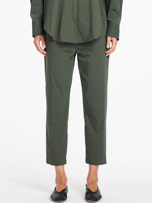 Image of a model wearing Pants. Product name - Mela Purdie Nomad Pant in Bayleaf colour by brand - Mela Purdie