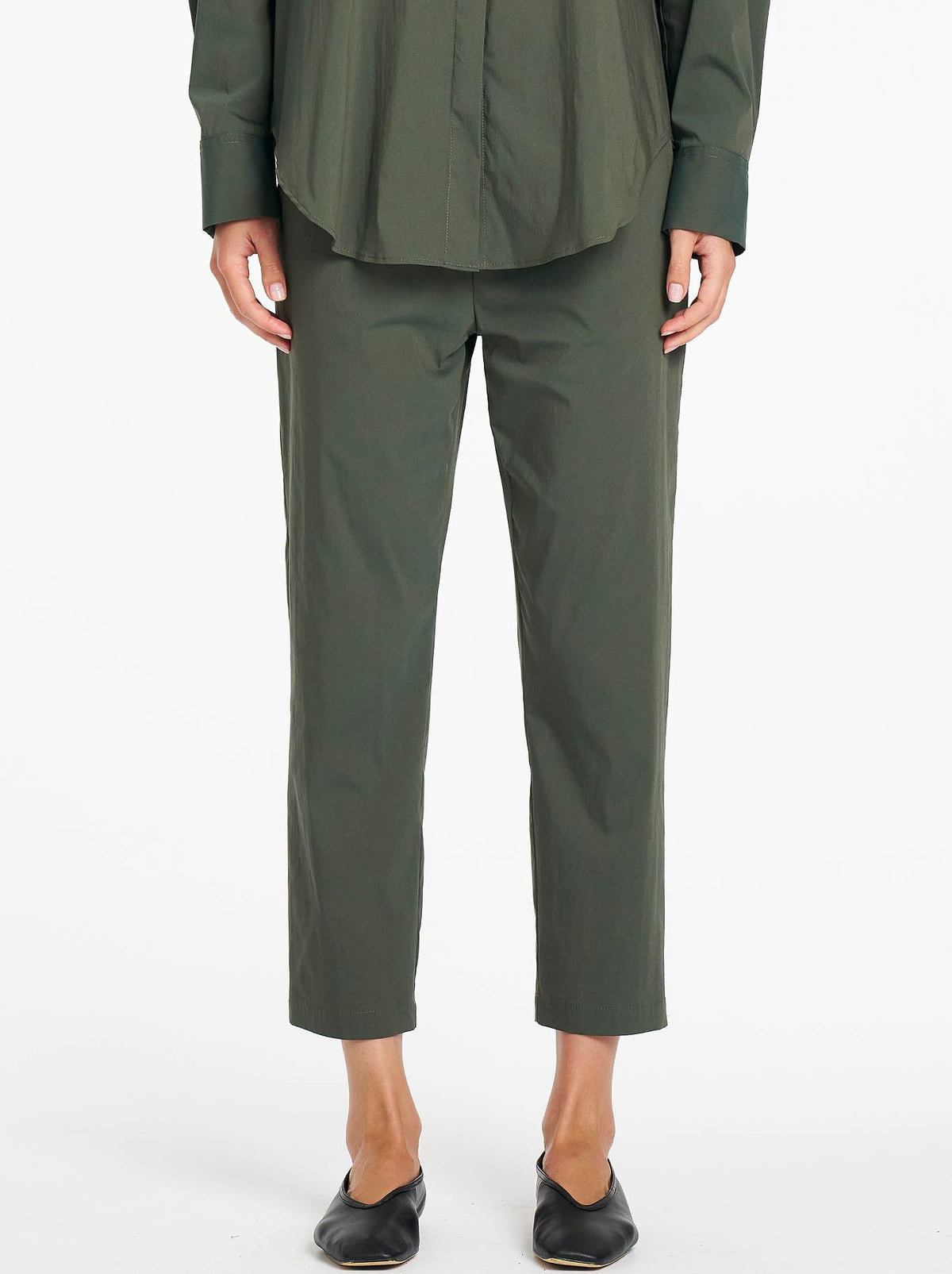Image of a model wearing Pants. Product name - Mela Purdie Nomad Pant in Bayleaf colour by brand - Mela Purdie