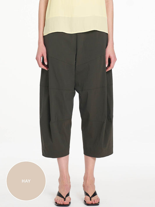 Image of a model wearing Pants. Product name - Mela Purdie Cropped Tuscan Pant in Hay colour by brand - Mela Purdie