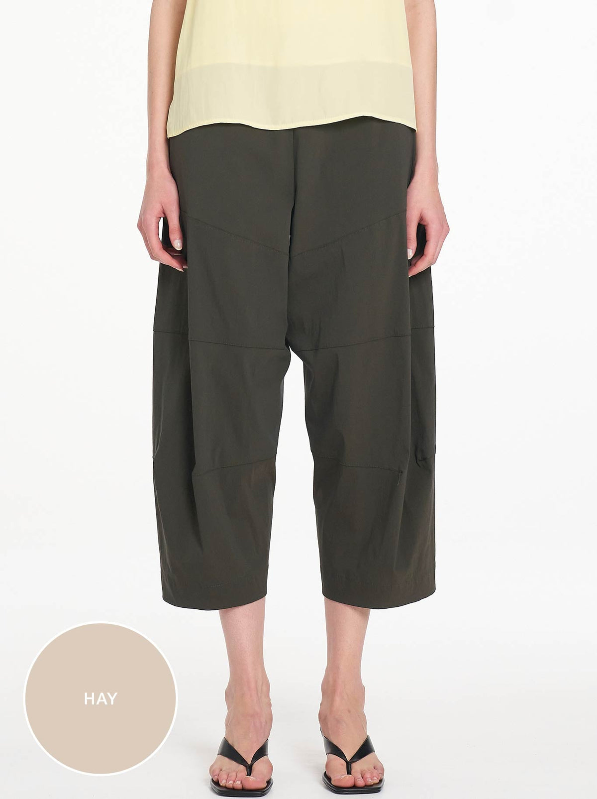Image of a model wearing Pants. Product name - MELA PURDIE CROPPED TUSCAN in Hay colour by brand - Mela Purdie