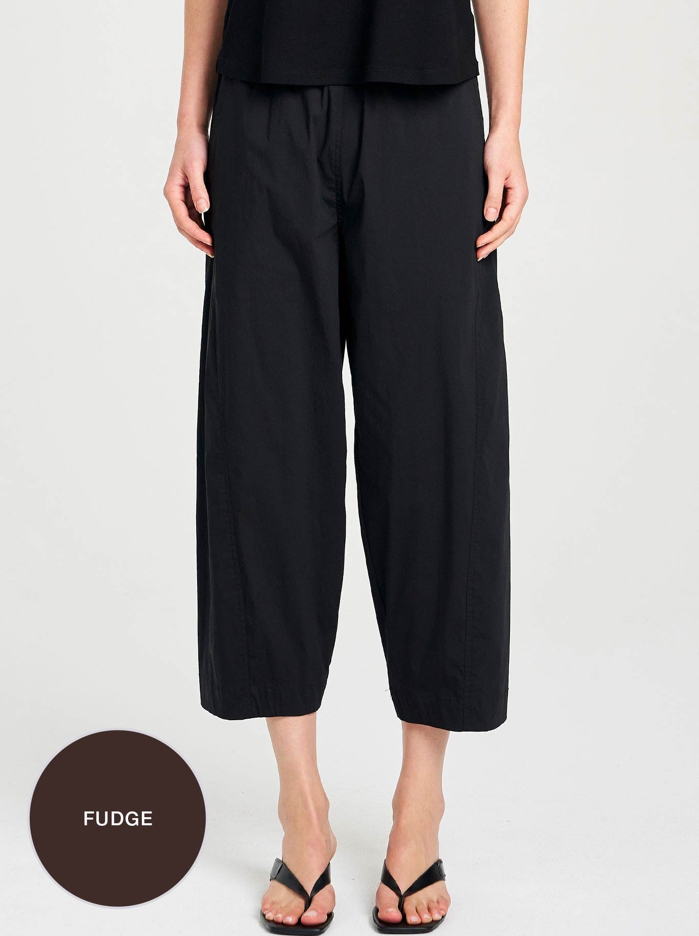 Image of a model wearing Pants. Product name - MELA PURDIE CROSS PANT in Black colour by brand - Mela Purdie
