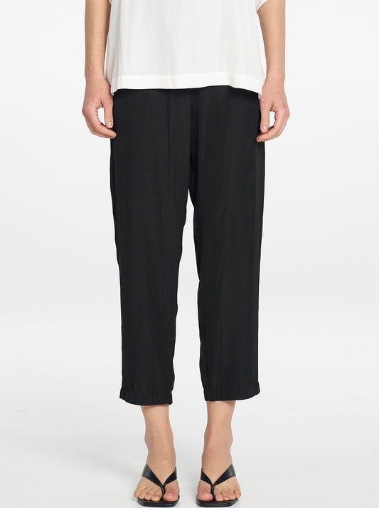Image of a model wearing Pants. Product name - MELA PURDIE SOFT ZIP PANT in Black colour by brand - Mela Purdie