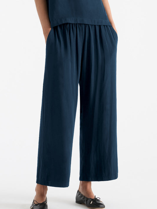 Image of a model wearing Pants. Product name - MELA PURDIE PACE PANT in Black colour by brand - Mela Purdie