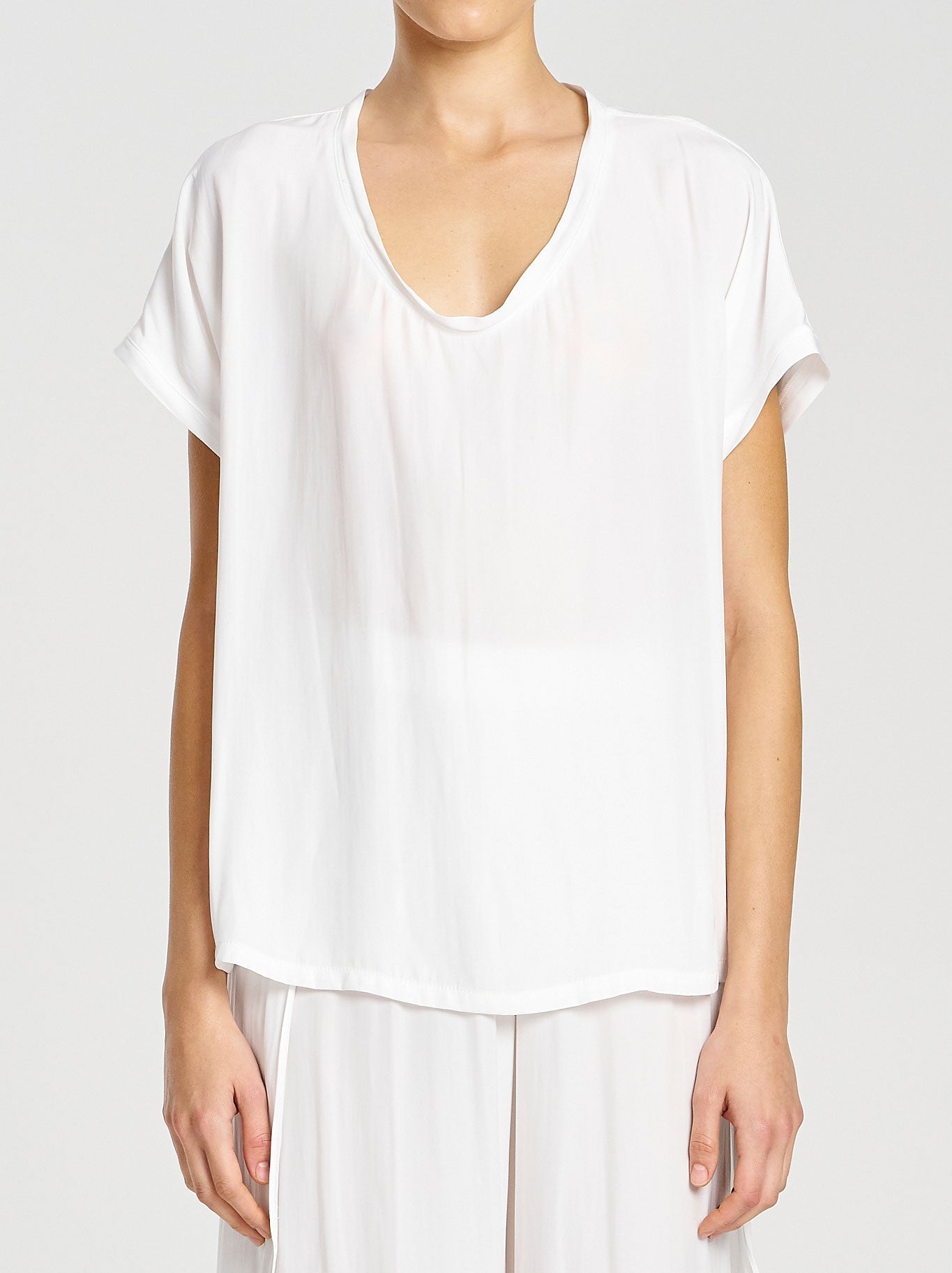 Image of a model wearing Tops. Productname: MELA PURDIE CRUISE SHELL in White colour by brand - Mela Purdie