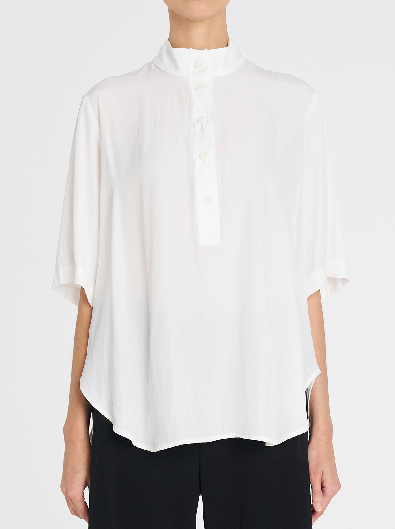 Image of a model wearing Tops. Productname: MELA PURDIE SWISH TAB PLAZA in White colour by brand - Mela Purdie
