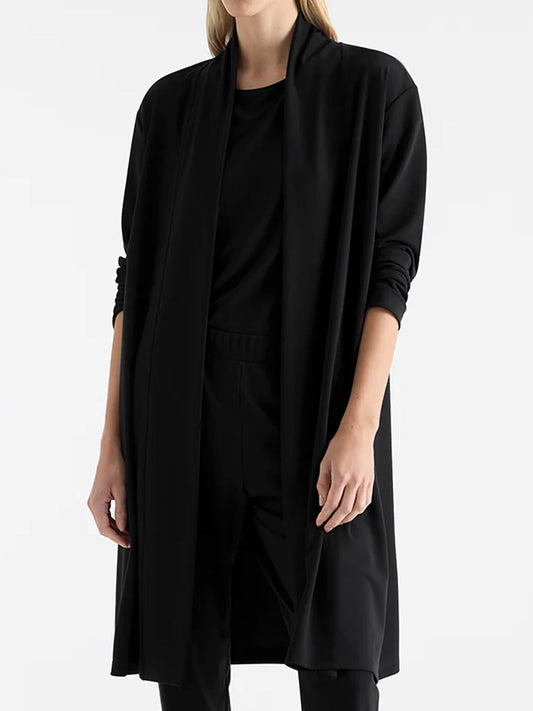 Image of a model wearing Outerwear. Productname: MELA PURDIE MARTINI COAT in Black colour by brand - Mela Purdie