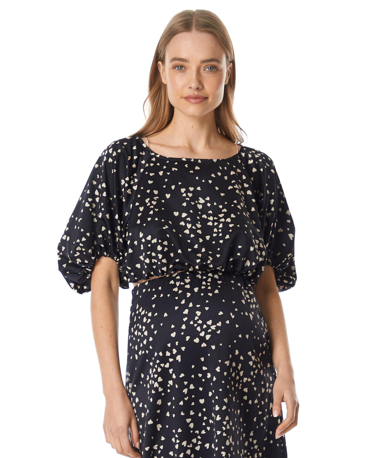 Image of a model wearing Tops. Product name - Mila Balloon Sleeve Top in Black Heart colour by brand - Soon Maternity