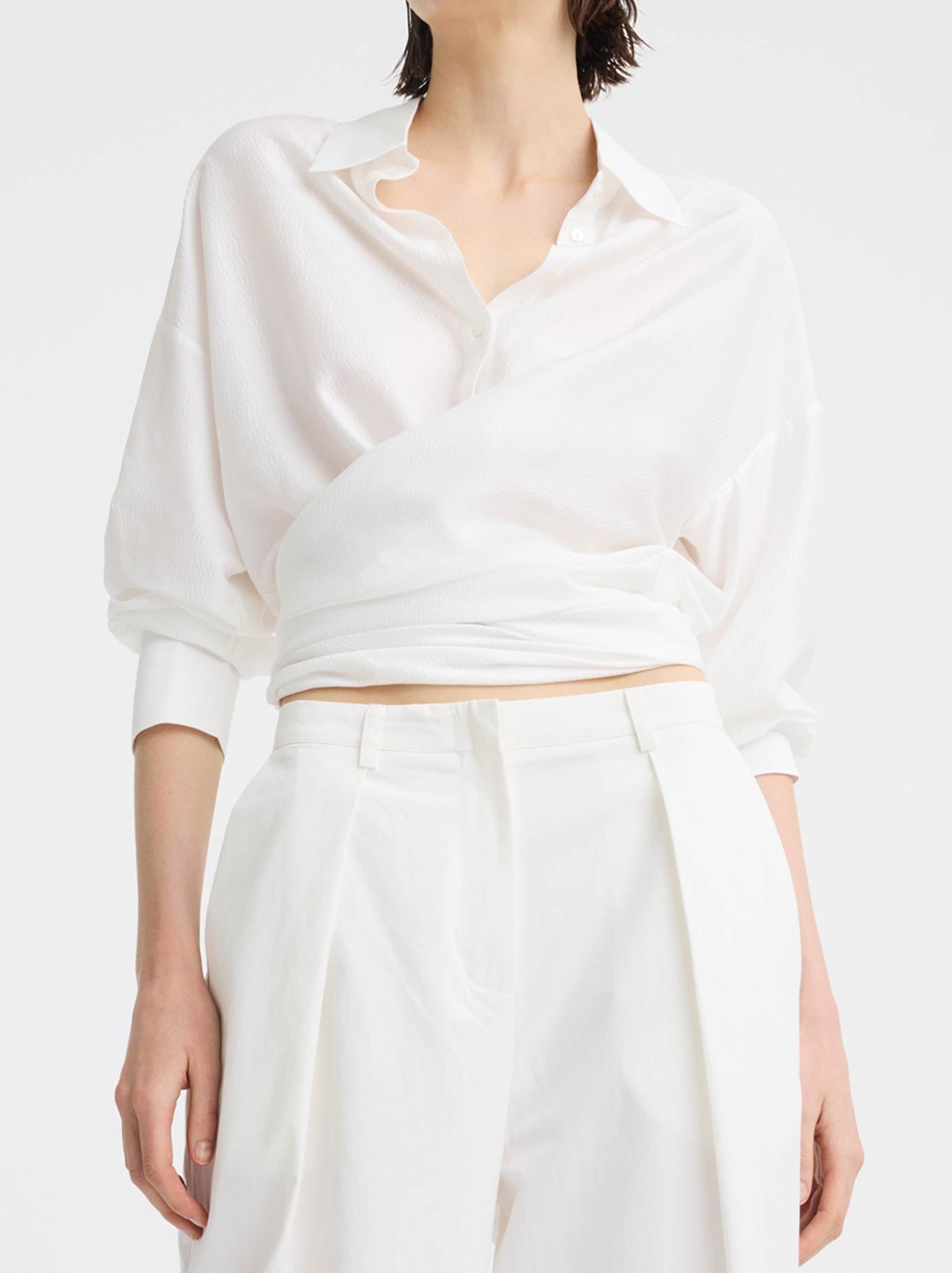 Image of a model wearing Tops. Product name - MORRISON CELINE WRAP SHIRT in White colour by brand - Morrison