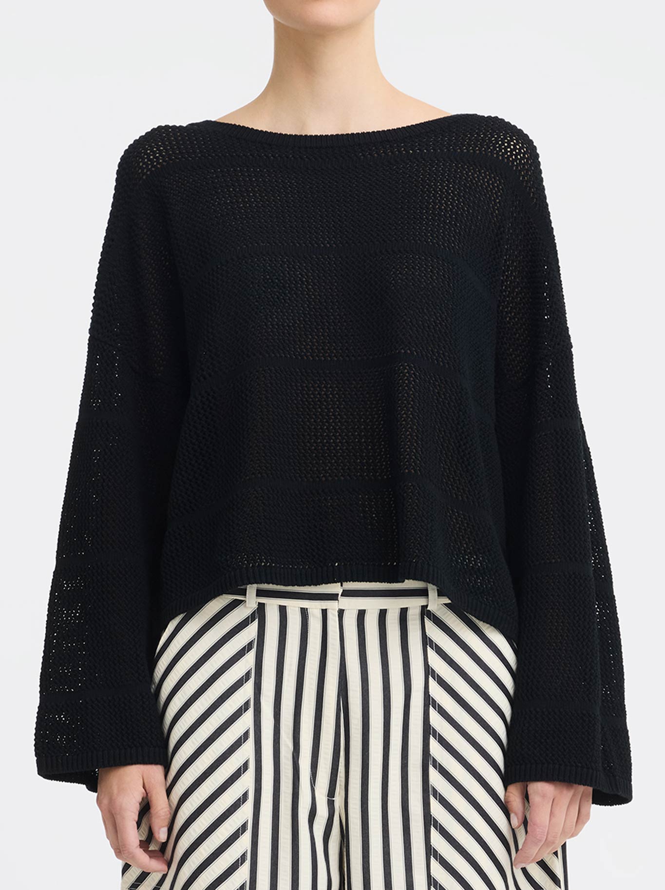 Image of a model wearing Outerwear. Product name - MORRISON ELIRA KNIT BOAT NECK in Black colour by brand - Morrison