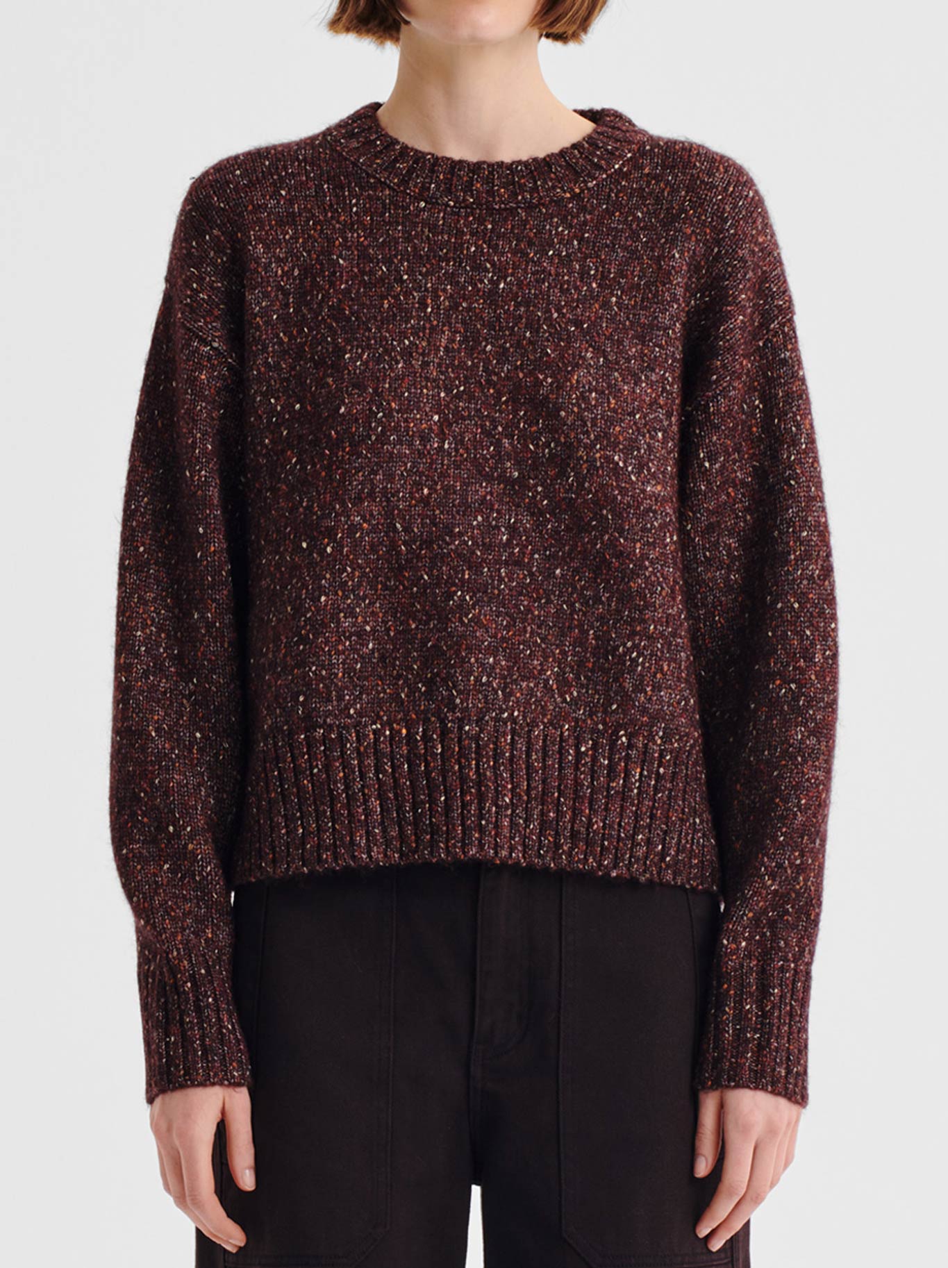 Image of a model wearing Outerwear. Product name - MORRISON ZOE KNIT PULLOVER in Boysenberry colour by brand - Morrison
