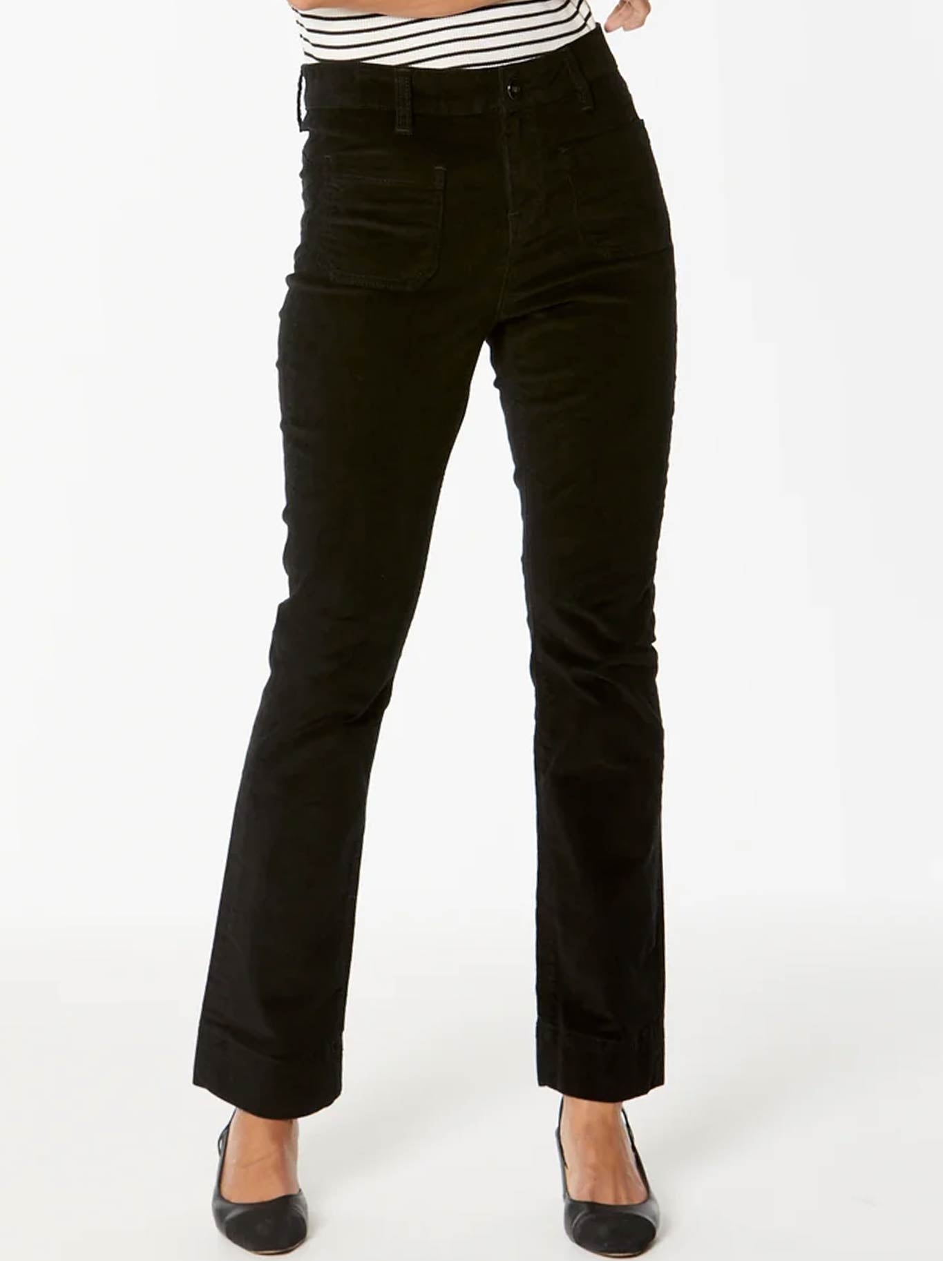 Image of a model wearing Pants. Product name - New London Fleet High-Rise Flare Cord in Black colour by brand - New London