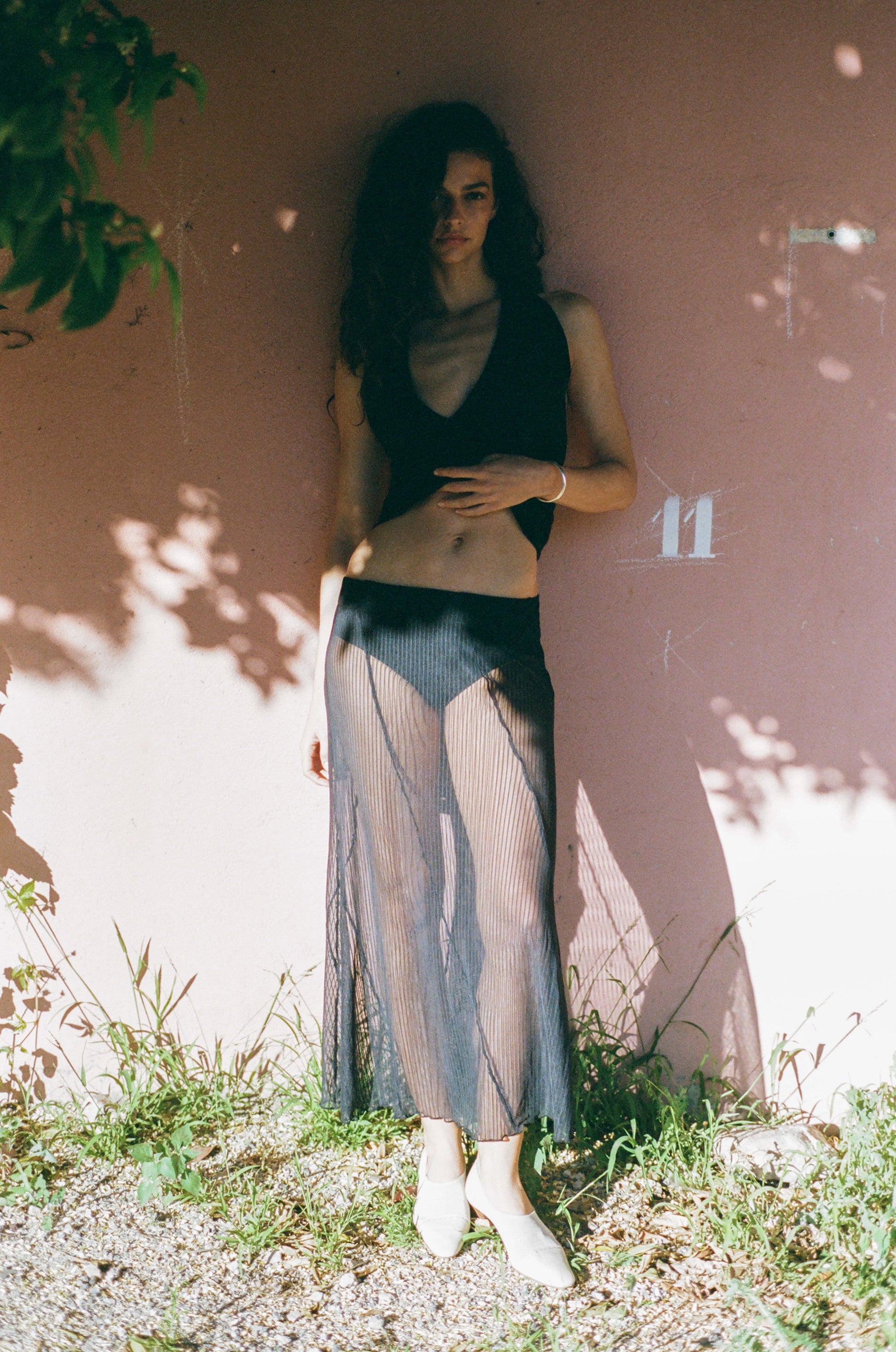 Image of a model wearing Skirts. Product name - Lorenzo Midi Skirt in Black colour by brand - With Jéan