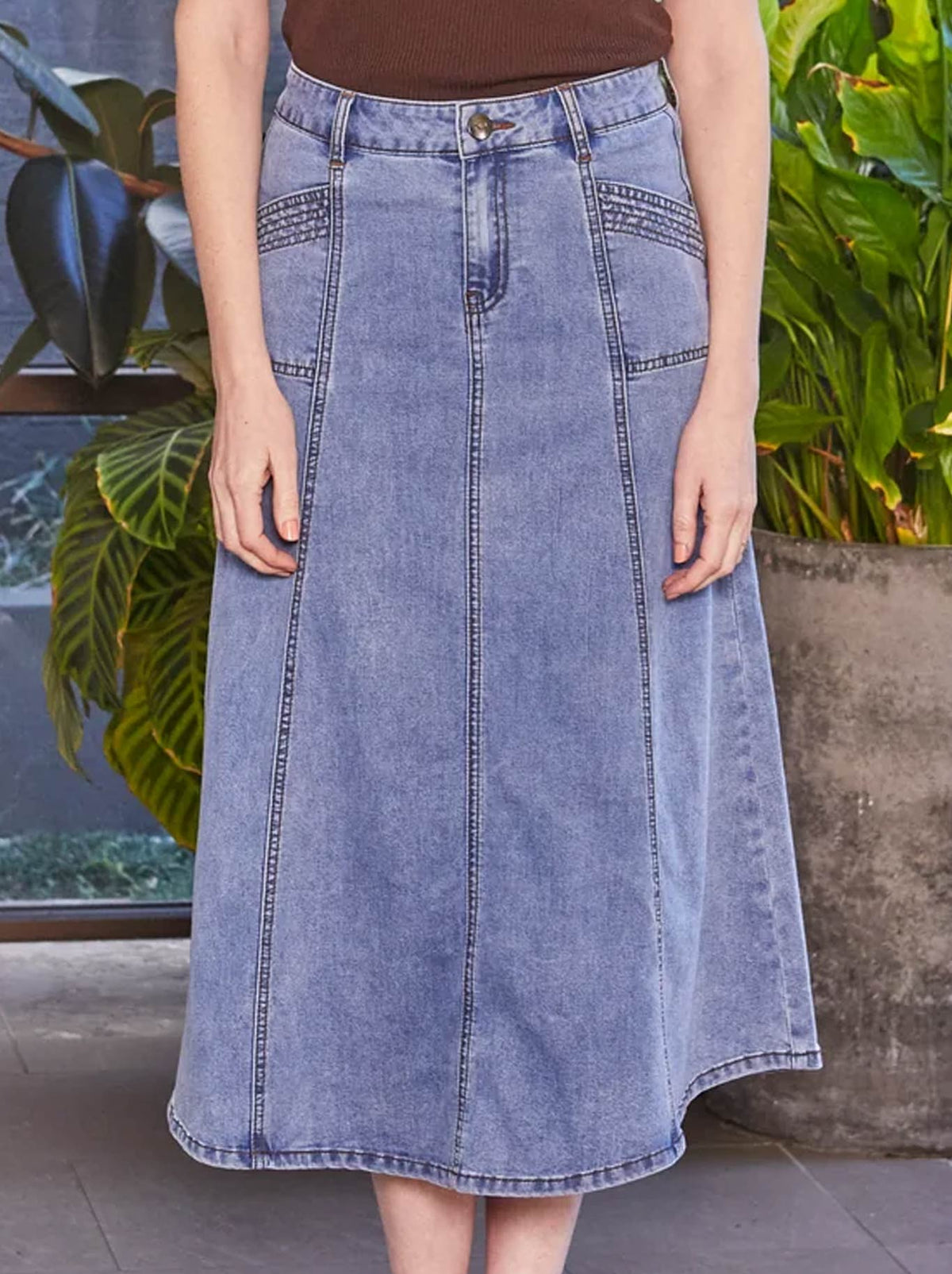 Image of a model wearing Skirts. Product name - NEW LONDON KENLEY MIDI SKIRT in Lightwash colour by brand - New London