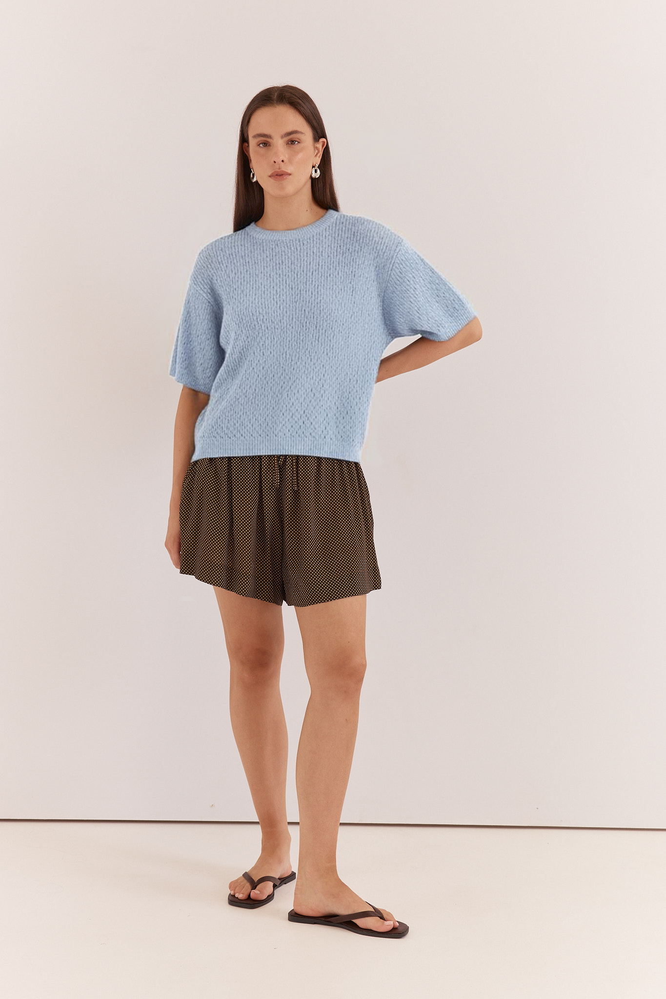 Image of a model wearing Tops. Product name - Noni Relaxed Knit Tee in Pale Blue colour by brand - Sass Clothing