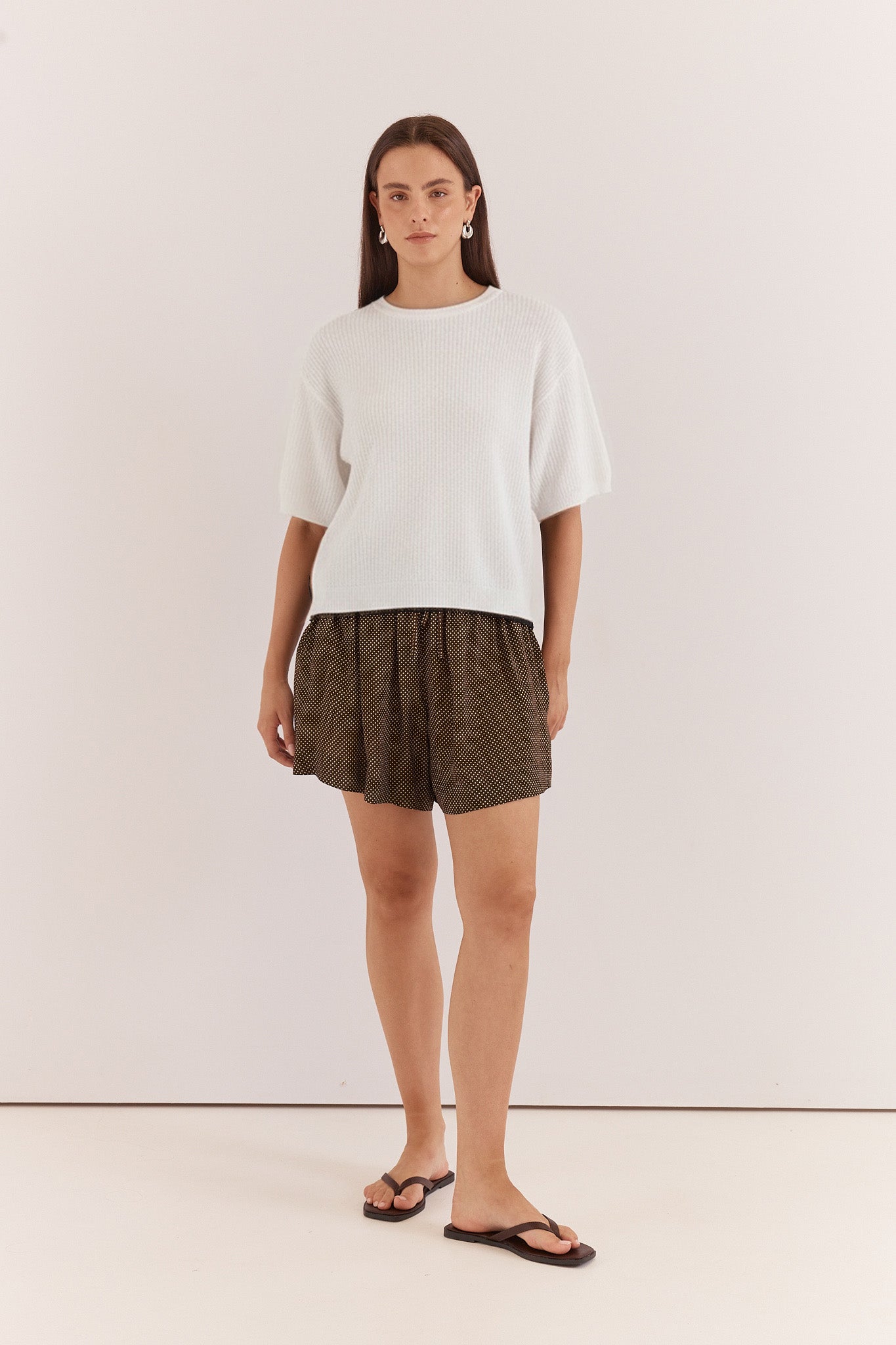 Image of a model wearing Tops. Product name - Noni Relaxed Knit Tee in Off White colour by brand - Sass Clothing