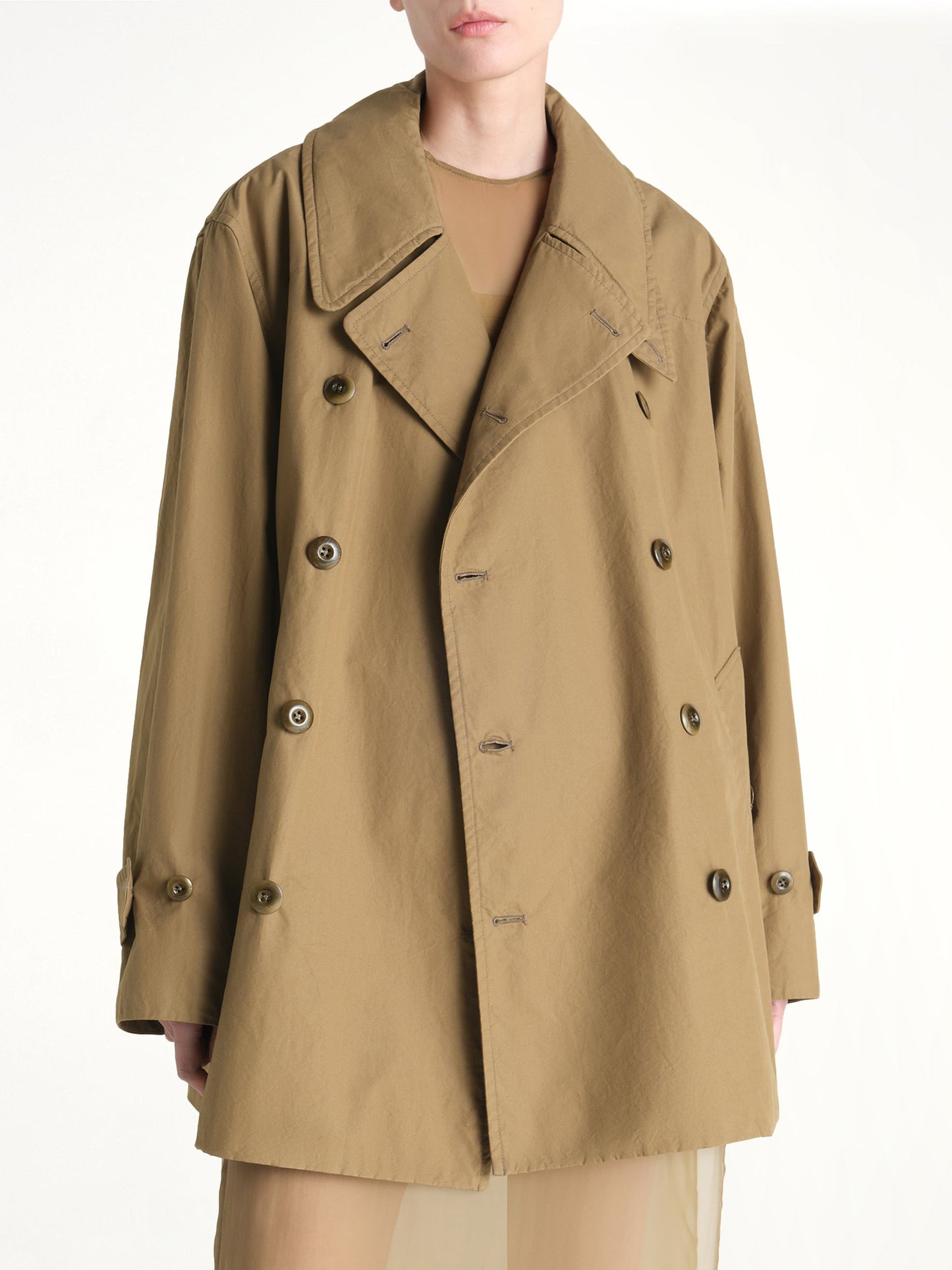 Image of a model wearing Outerwear. Product name - Cropped Trench in Khaki colour by brand - LEMAIRE