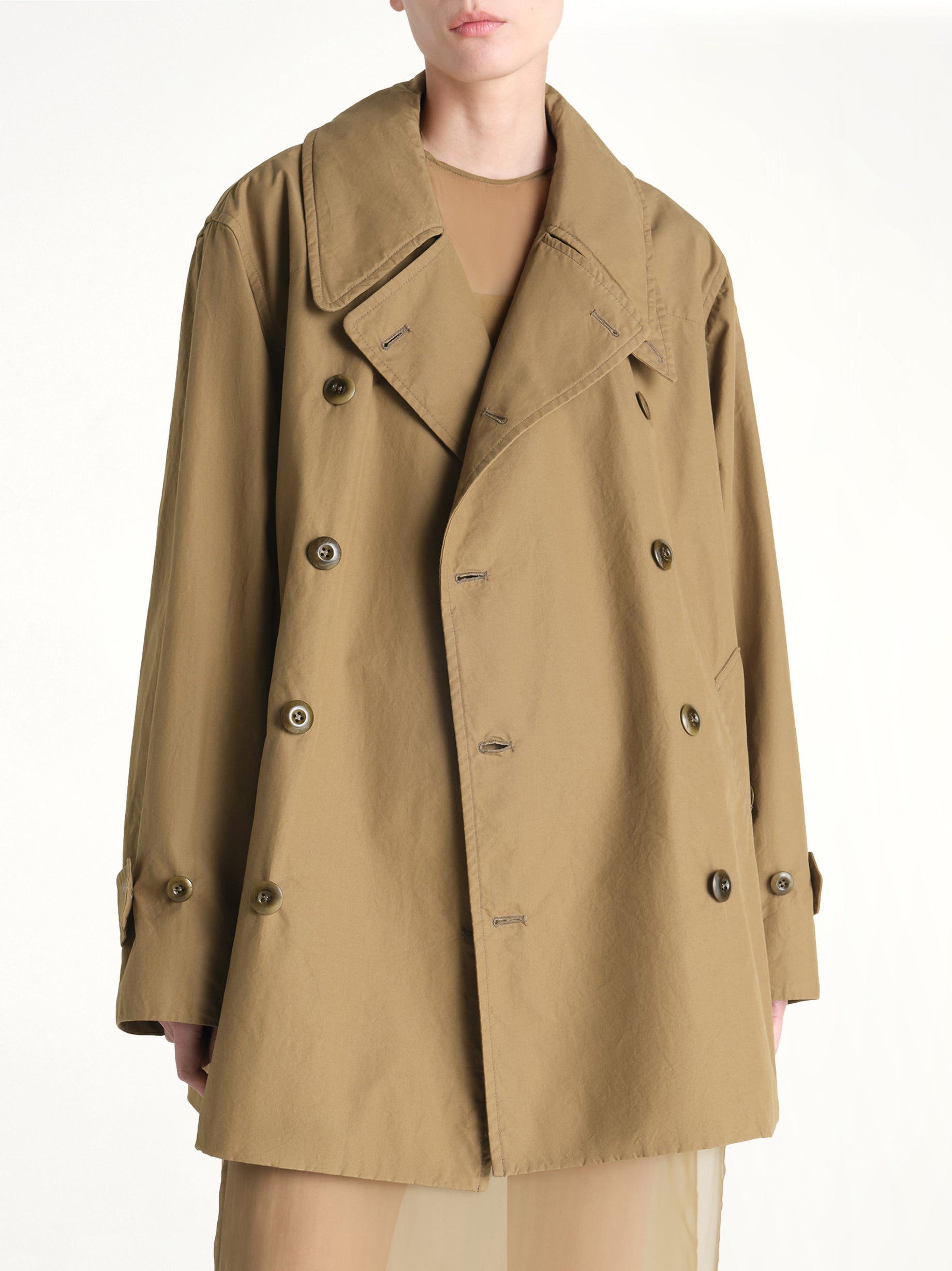Image of a model wearing Outerwear. Product name - Cropped Trench in Khaki colour by brand - LEMAIRE