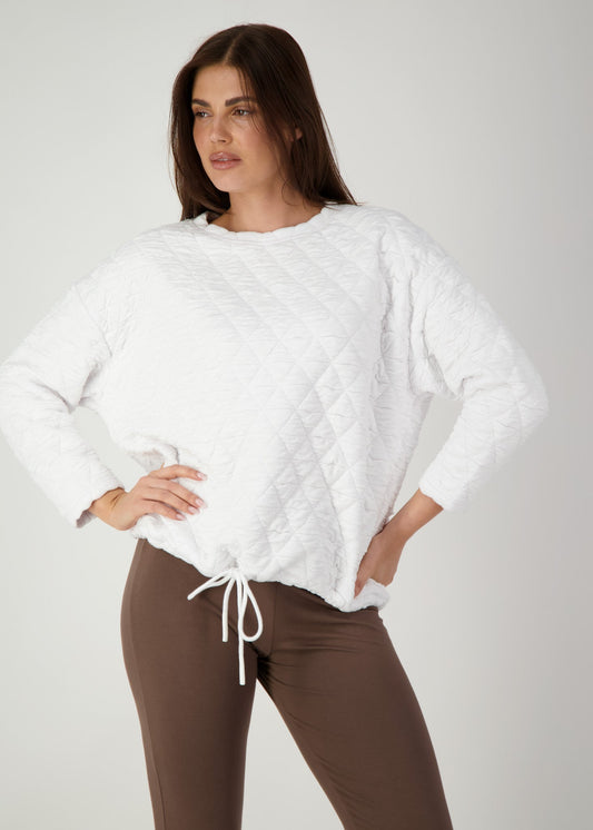 Image of a model wearing Tops. Product name - Sacha Oversized Quilted Bamboo Sweater White in White colour by brand - Lou Lou