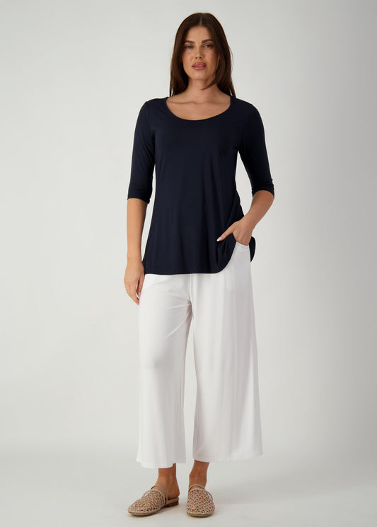 Image of a model wearing Tops. Product name - Aretha 3/4 Sleeve Bamboo Top Navy in Navy colour by brand - Lou Lou