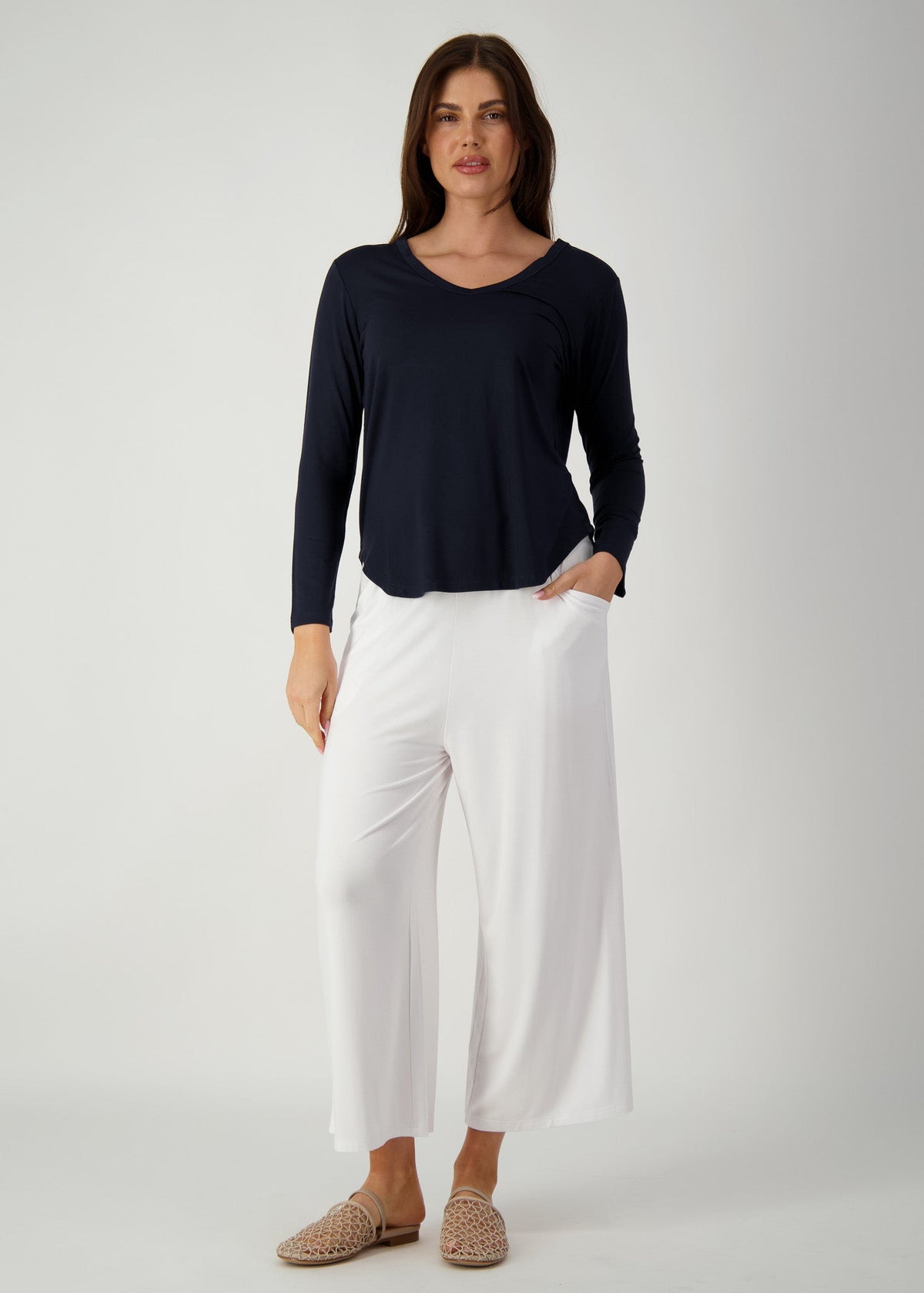 Image of a model wearing Tops. Product name - Sia V Neck Bamboo Longsleeve Top in Navy colour by brand - Lou Lou