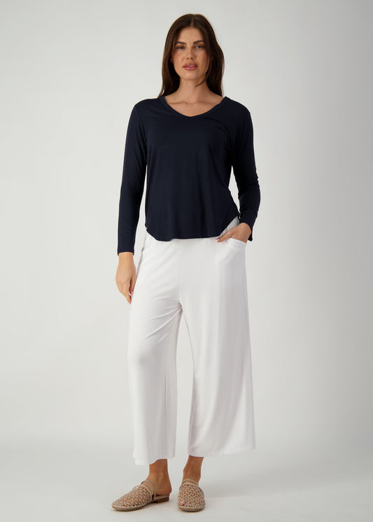 Image of a model wearing Tops. Product name - Sia V Neck Bamboo Longsleeve Top in Navy colour by brand - Lou Lou