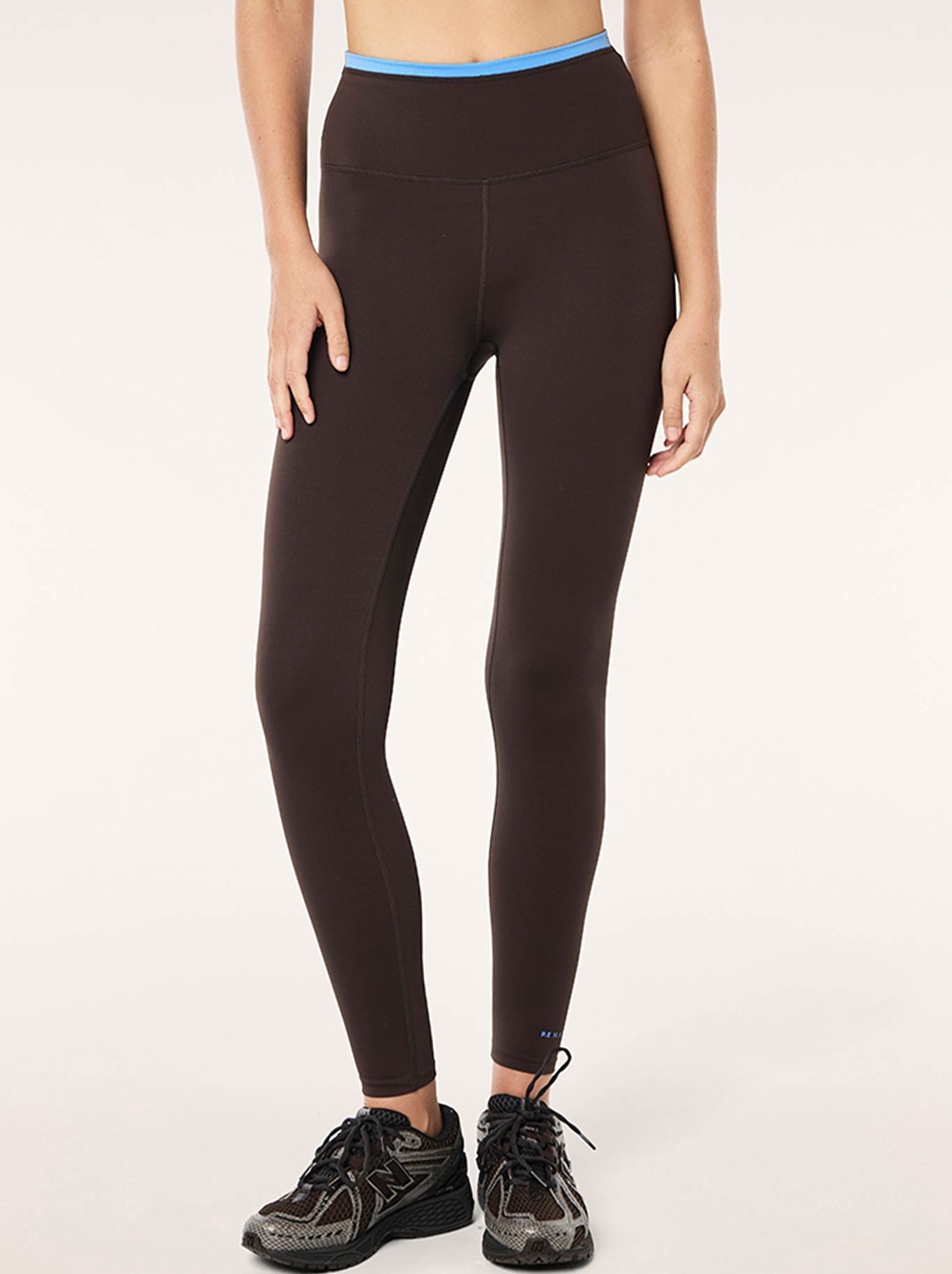 Image of a model wearing Pants. Product name - P.E NATION VITA FULL LENGTH LEGGING in Coffee Marina colour by brand - P.E Nation
