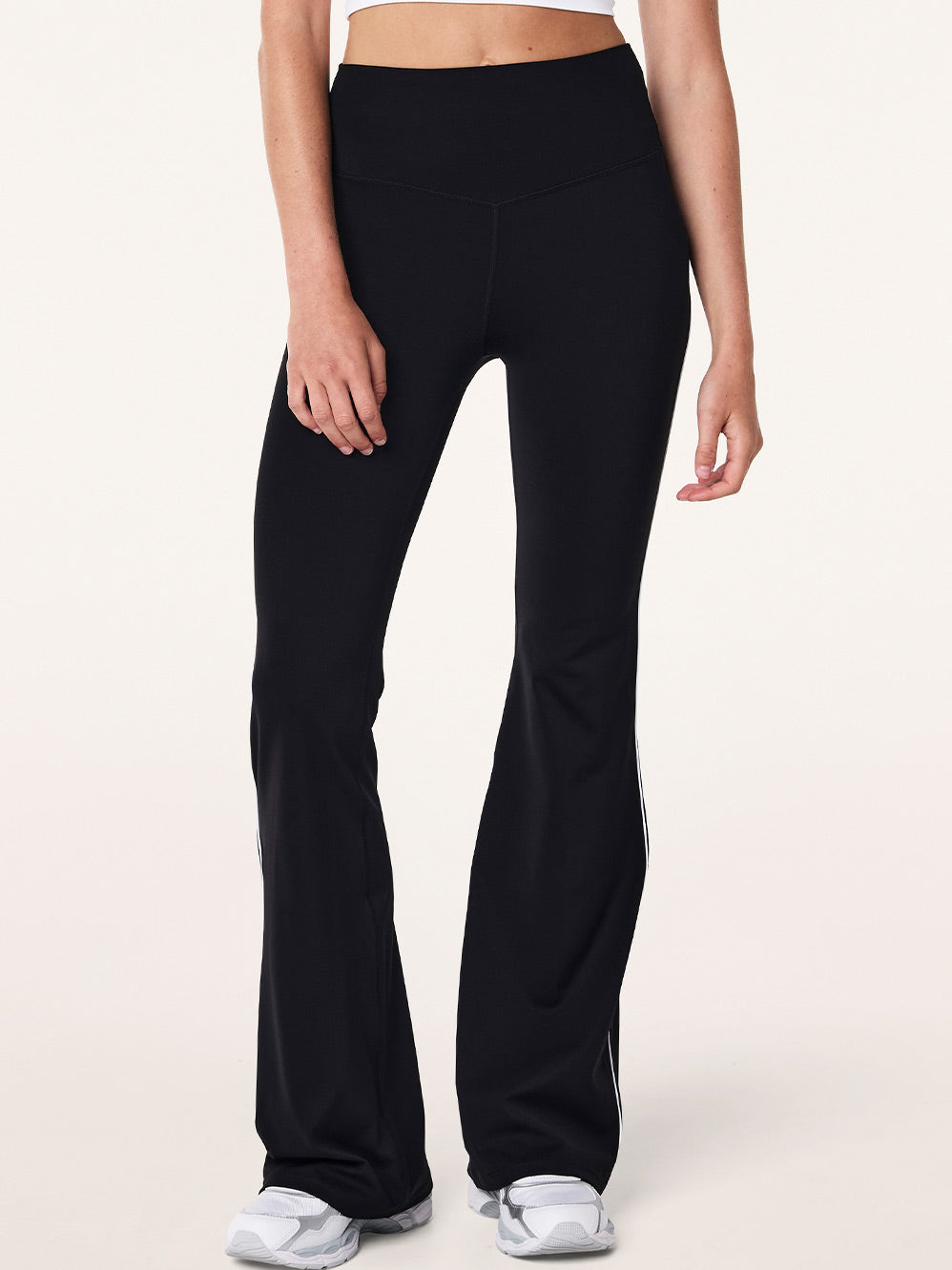 Image of a model wearing Pants. Product name - P.E NATION PREVIEW PIPING LEGGING in Coffee colour by brand - P.E Nation