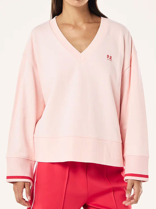 Image of a model wearing Outerwear. Productname: P.E NATION COURTSIDE V NECK SWEAT in Petal colour by brand - P.E Nation