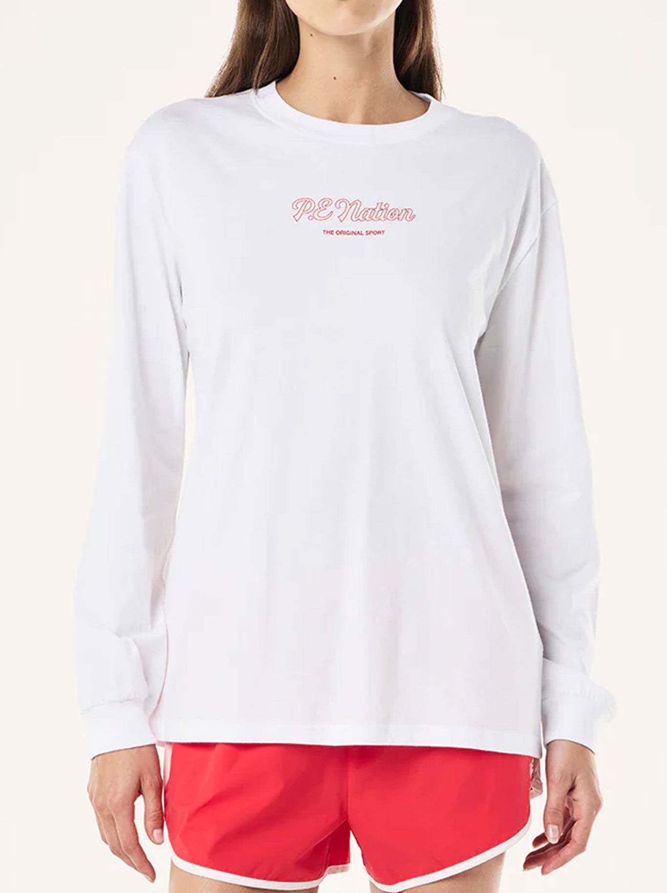 Image of a model wearing Tops. Productname: P.E NATION FORMATION LONG SLEEVE TEE in Optic White colour by brand - P.E Nation