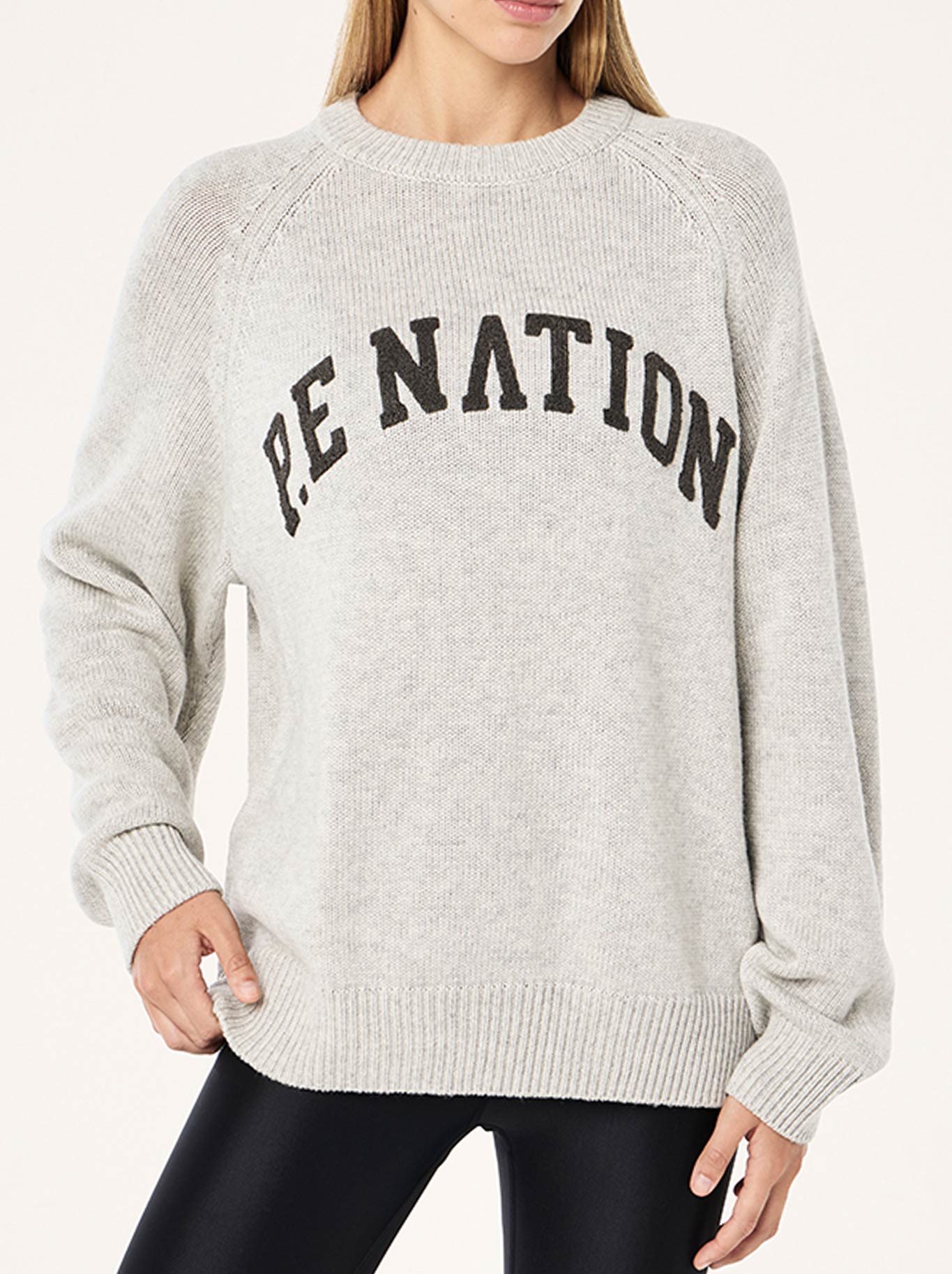 Image of a model wearing Outerwear. Product name - P.E NATION LEGACY KNIT CREW in Snow colour by brand - P.E Nation