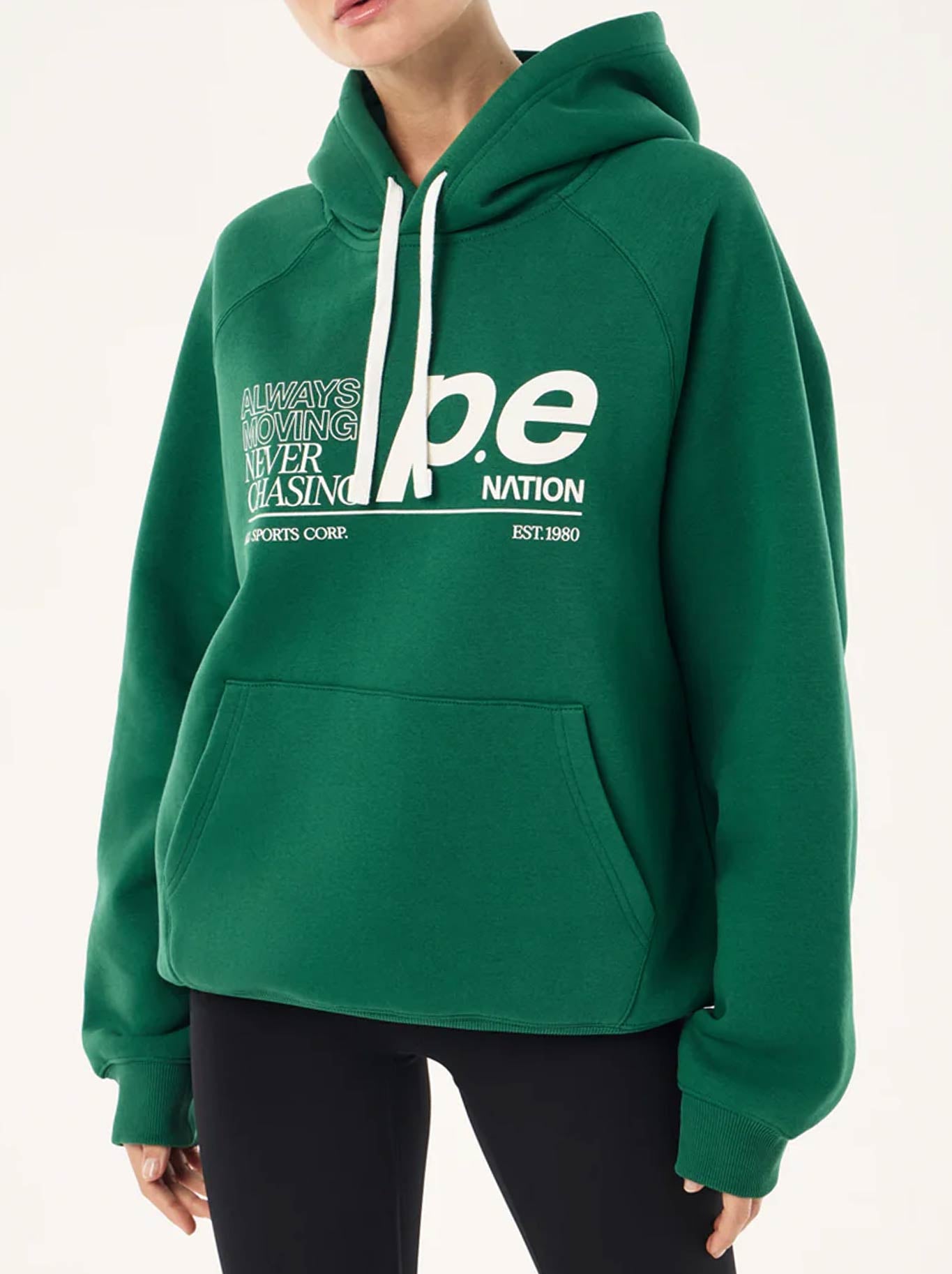 Image of a model wearing Tops. Product name - P.E NATION CURRENT HOODIE in Amazon colour by brand - P.E Nation