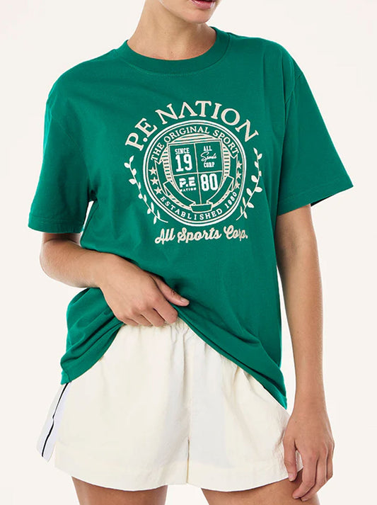 Image of a model wearing Tops. Productname: P.E NATION DEFEND TEE in College Green colour by brand - P.E Nation