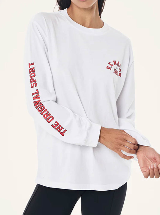 Image of a model wearing Tops. Product name - P.E NATION ESTABLISHED LONG SLEEVE TEE in Optic White colour by brand - P.E Nation