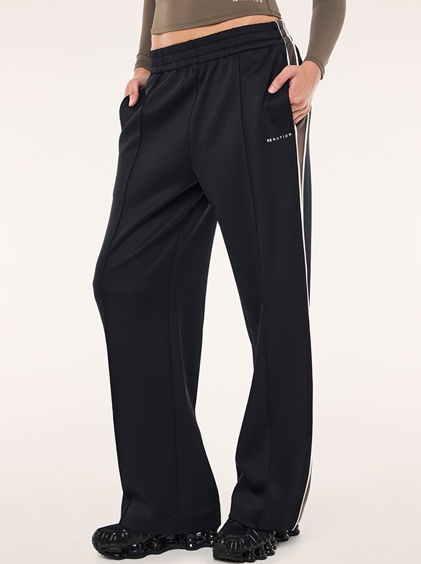 Image of a model wearing Pants. Productname: P.E NATION MAN DOWN TRACK PANT in Black Major Brown colour by brand - P.E Nation