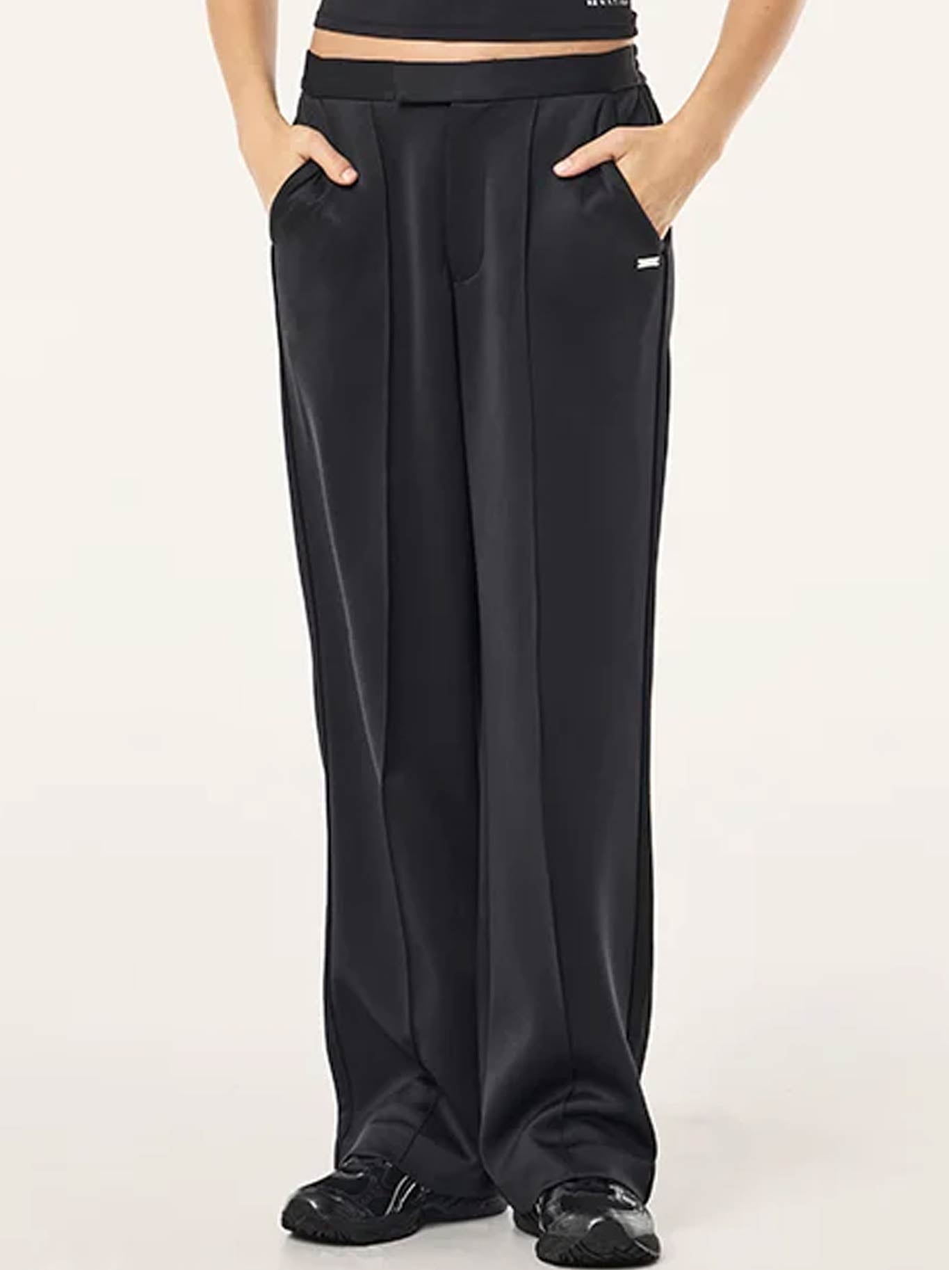 Image of a model wearing Pants. Product name - P.E NATION ORBIT PANT in Black colour by brand - P.E Nation