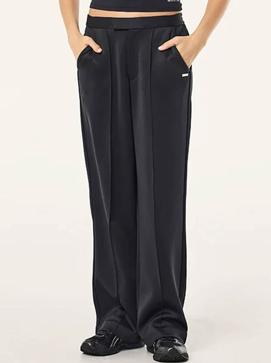 Image of a model wearing Pants. Product name - P.E NATION ORBIT PANT in Black colour by brand - P.E Nation