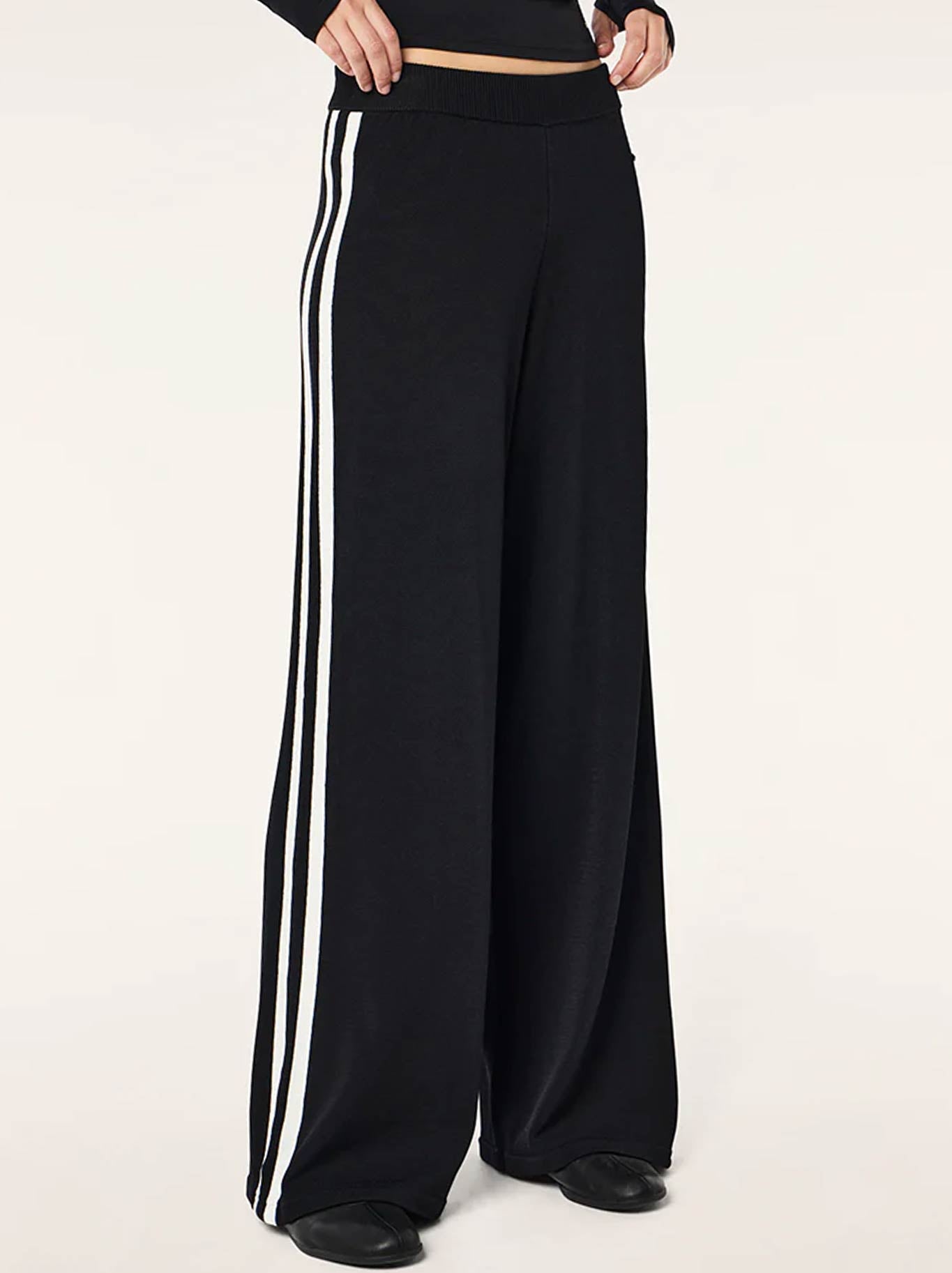 Image of a model wearing Pants. Product name - P.E NATION RETREAT KNIT PANT in Black/Whisper White colour by brand - P.E Nation