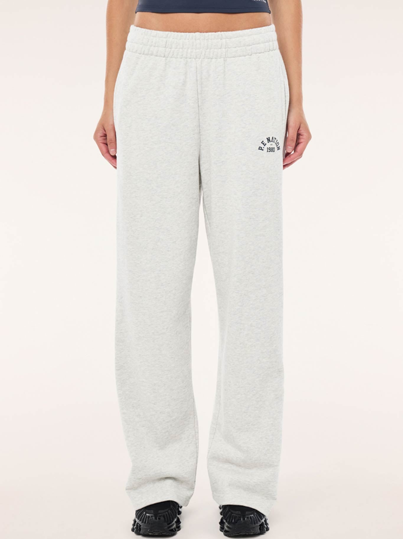 Image of a model wearing Pants. Productname: P.E NATION SWERVE TRACK PANT in Grey Marle colour by brand - P.E Nation