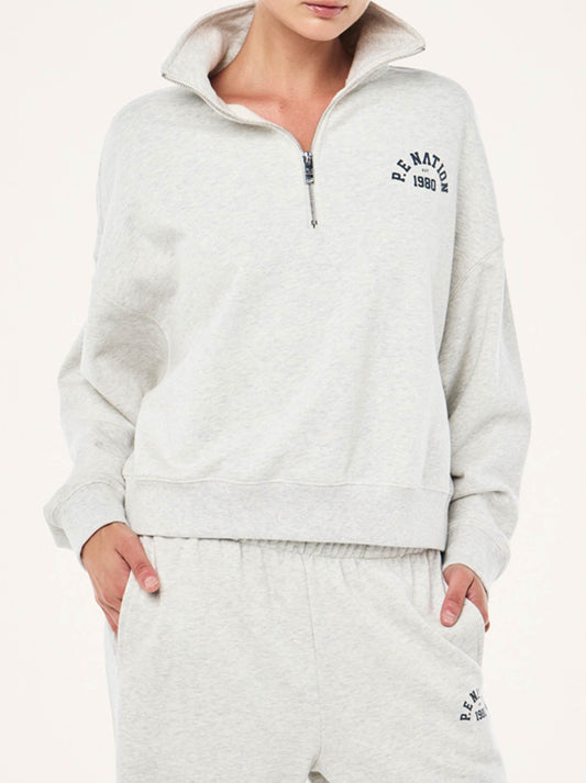 Image of a model wearing Tops. Productname: P.E NATION SWERVE ZIP NECK in Grey Marle colour by brand - P.E Nation