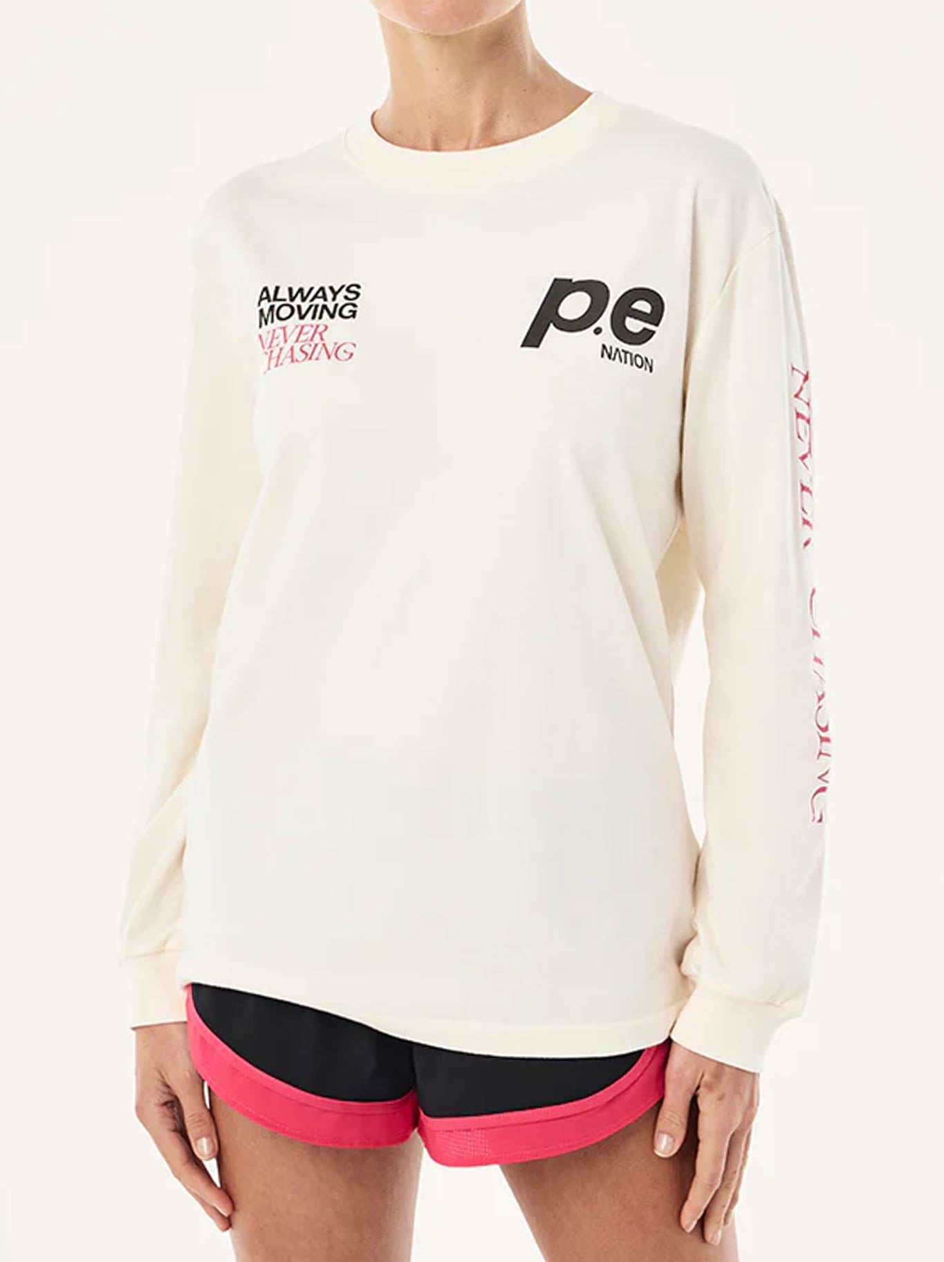 Image of a model wearing Tops. Product name - P.E NATION VOLTAGE LONG SLEEVE TEE in Whisper White colour by brand - P.E Nation