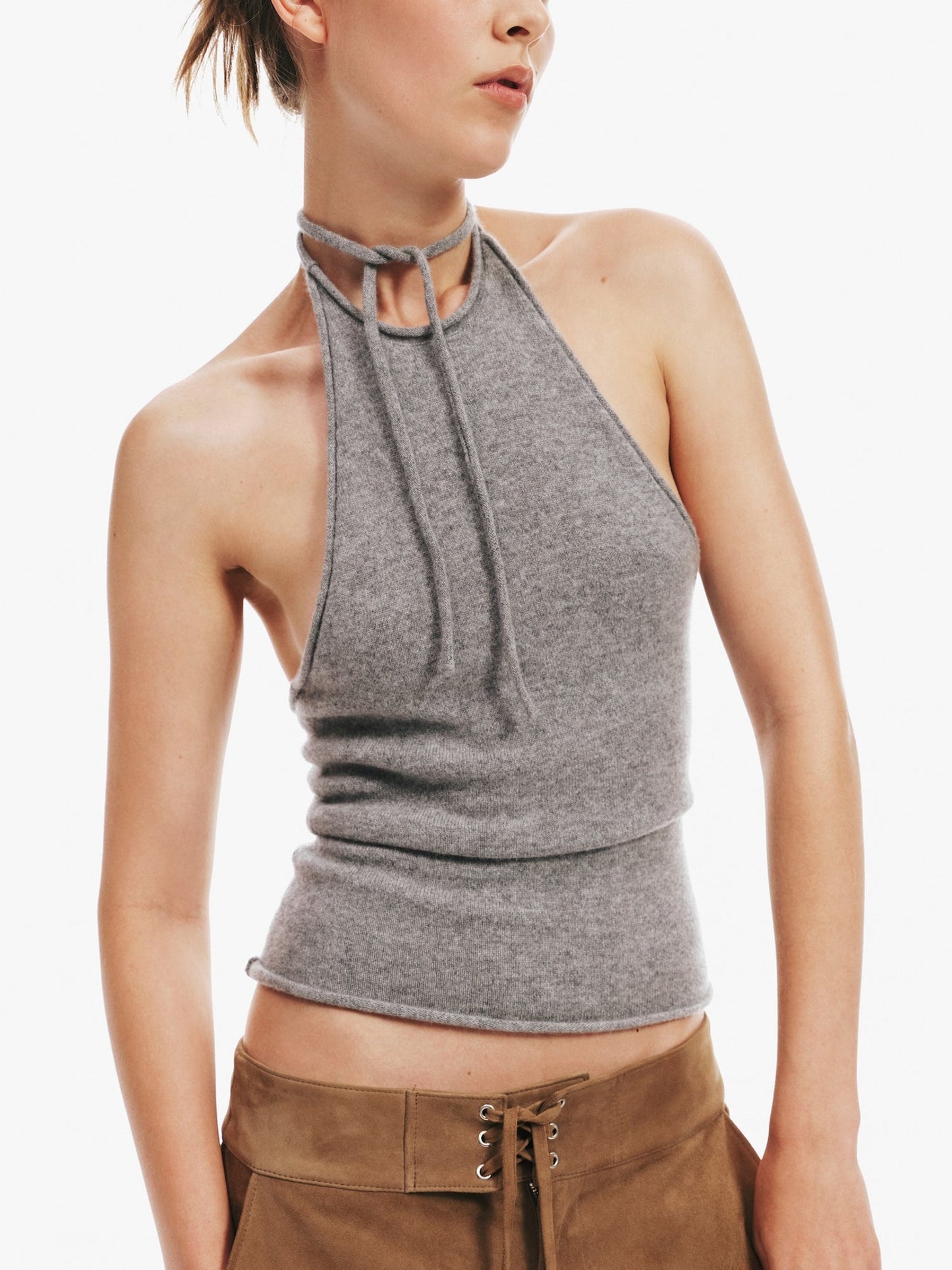 Image of a model wearing Tops. Product name - Cashmere Rae Halter Tank in Marle colour by brand - Christopher Esber