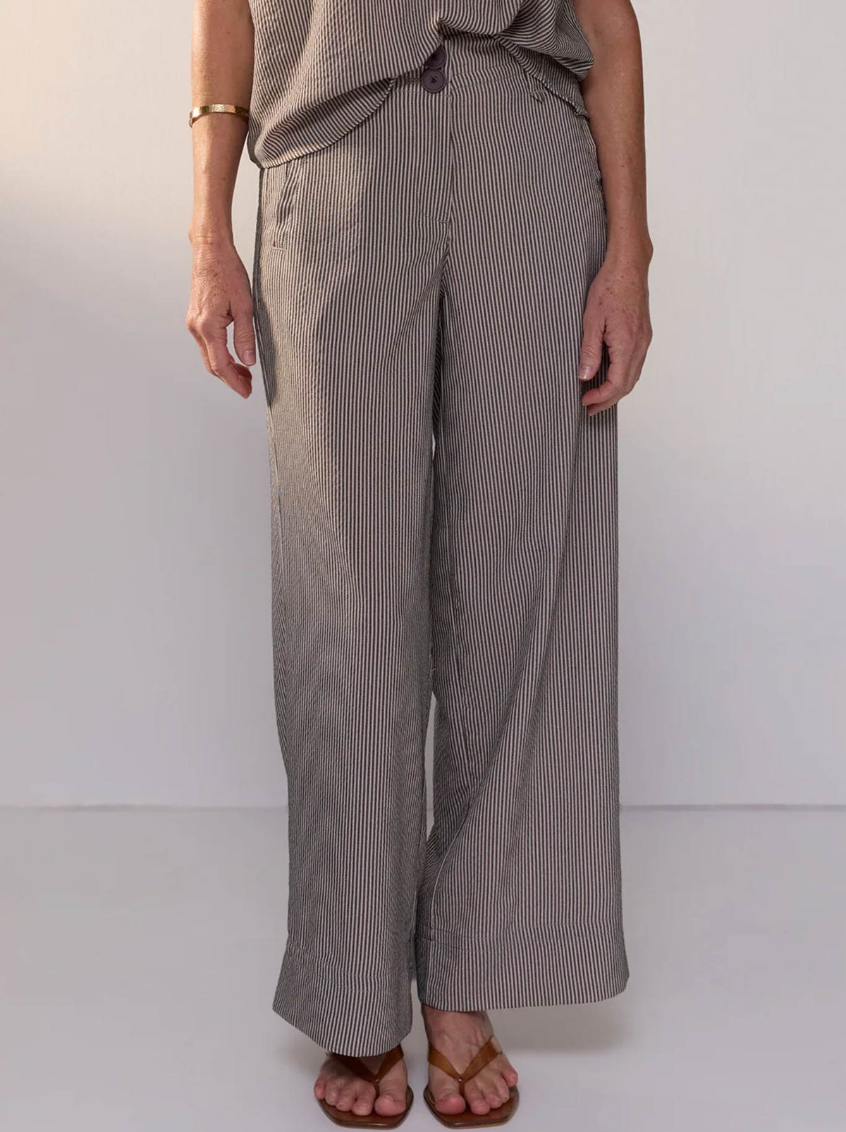Image of a model wearing Pants. Product name - POL DYLAN PANT in Shadow Stripe colour by brand - Pol