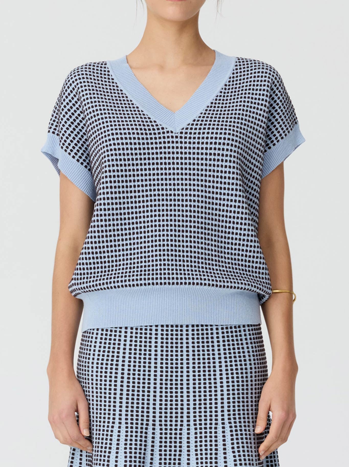Image of a model wearing Tops. Product name - Pol Evlyn Knit Top in Blue Choc colour by brand - Pol
